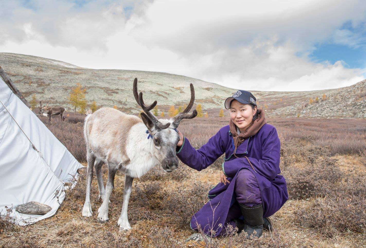 A Mongolian guide with a reindeer.