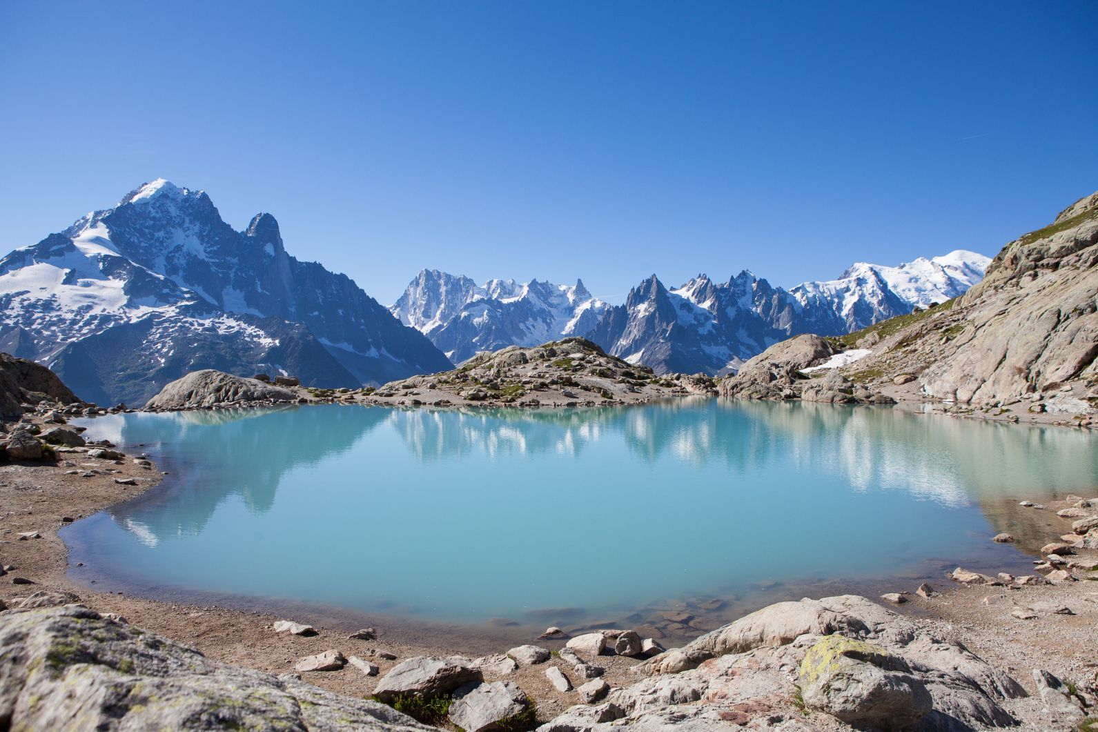 The snow-capped Mont Blanc massif reflected in the crystal waters of Lac Blanc in the French Alps