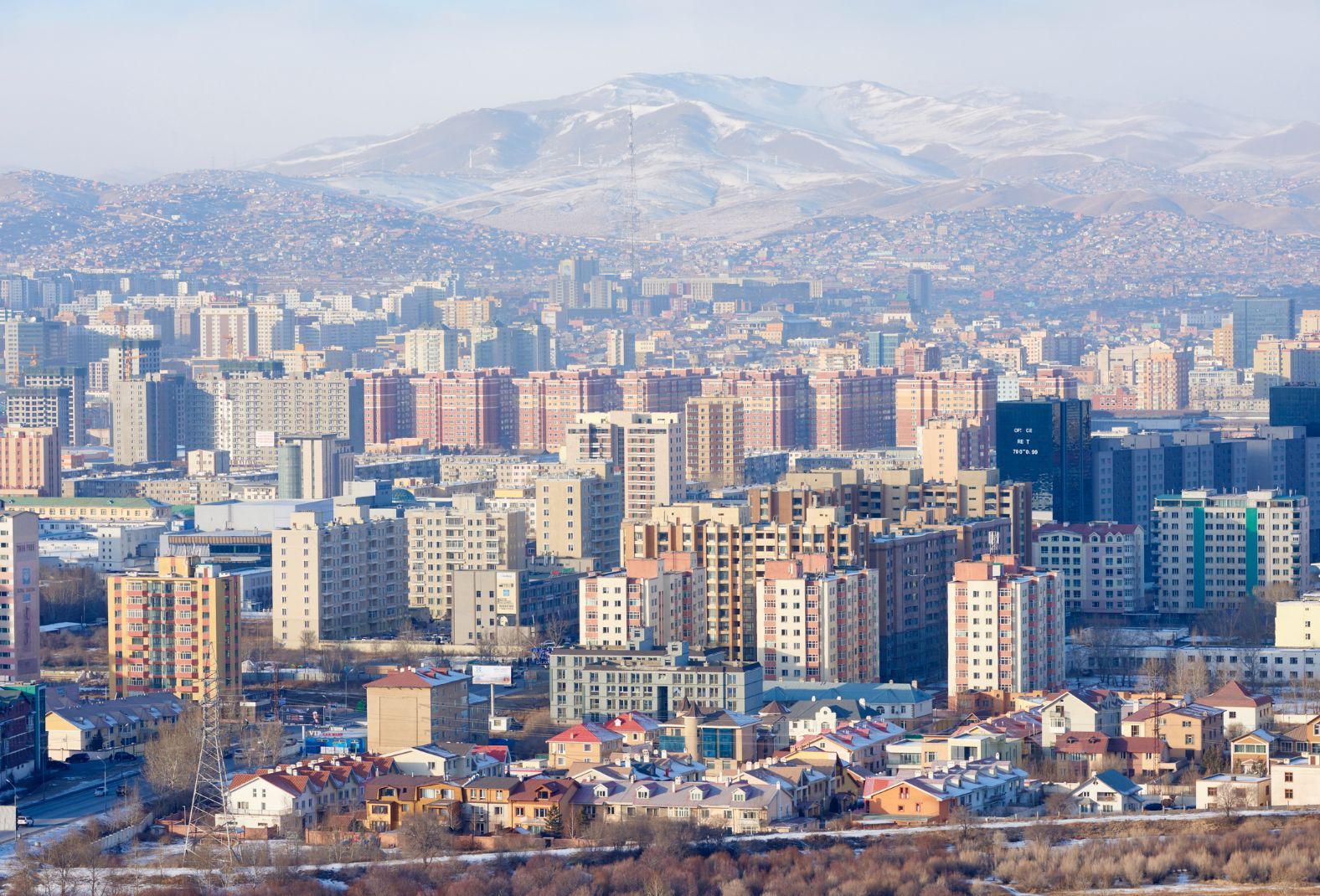 The sprawling scenery of downtown Ulaanbaatar in Mongolia and beyond, into the hills, full of gers, behind