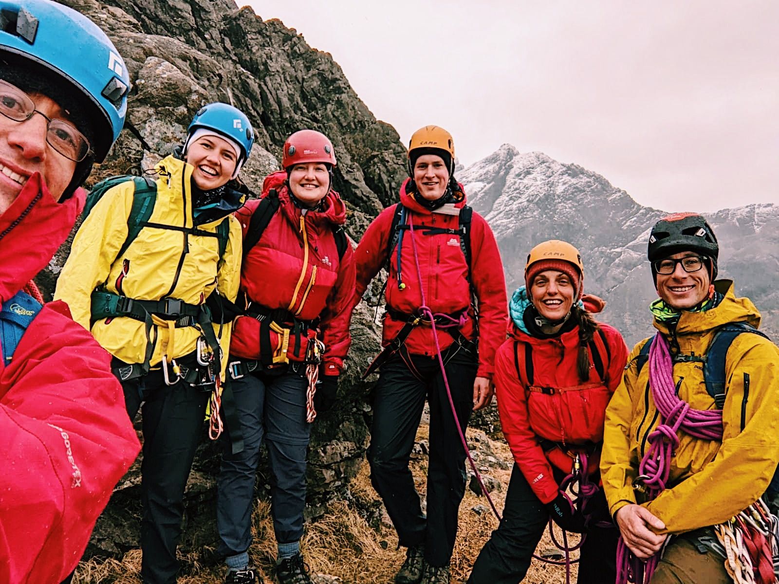 A Much Better Adventures group posing on a mountain on the Isle of Skye.