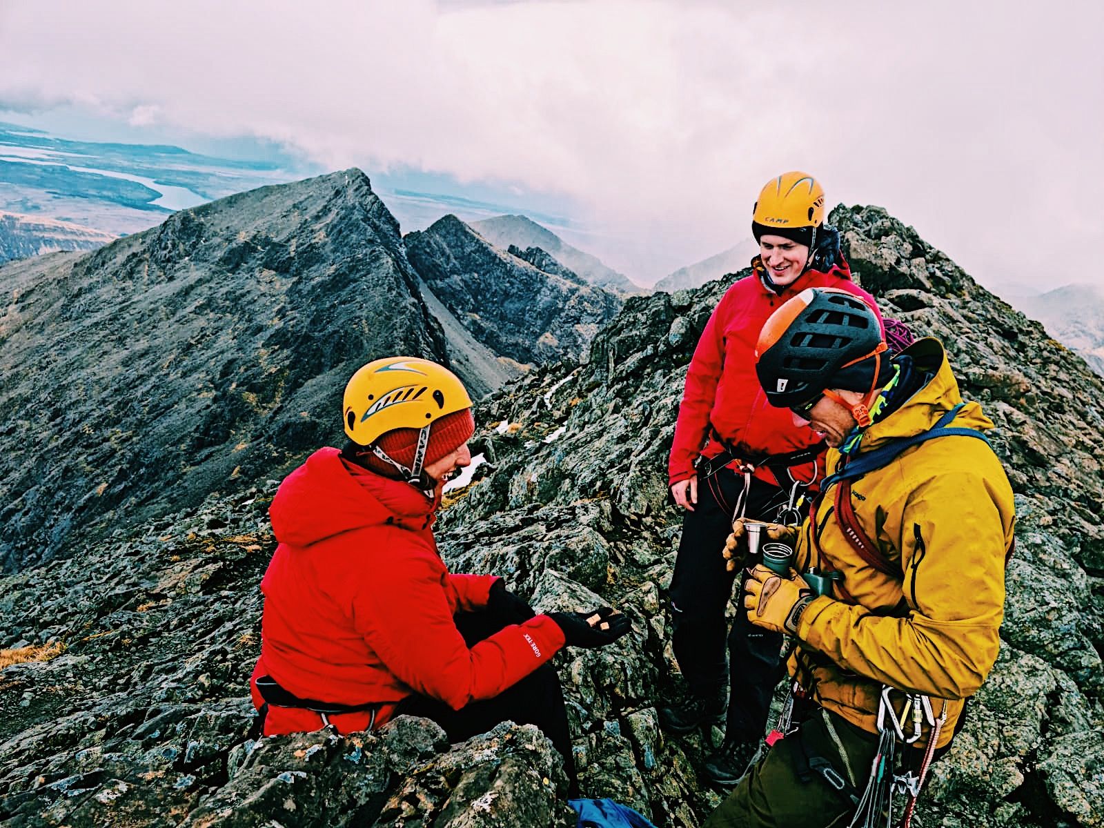 Climbers on a mountain on the Isle of Skye, celebrating an ascent with a wee dram.