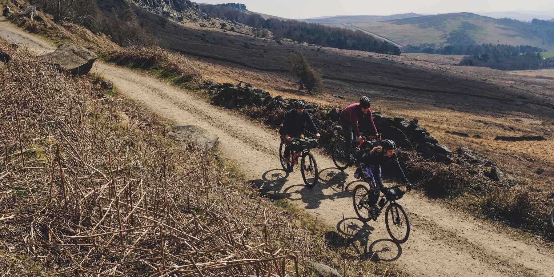 Three bikepackers in the Peak District.