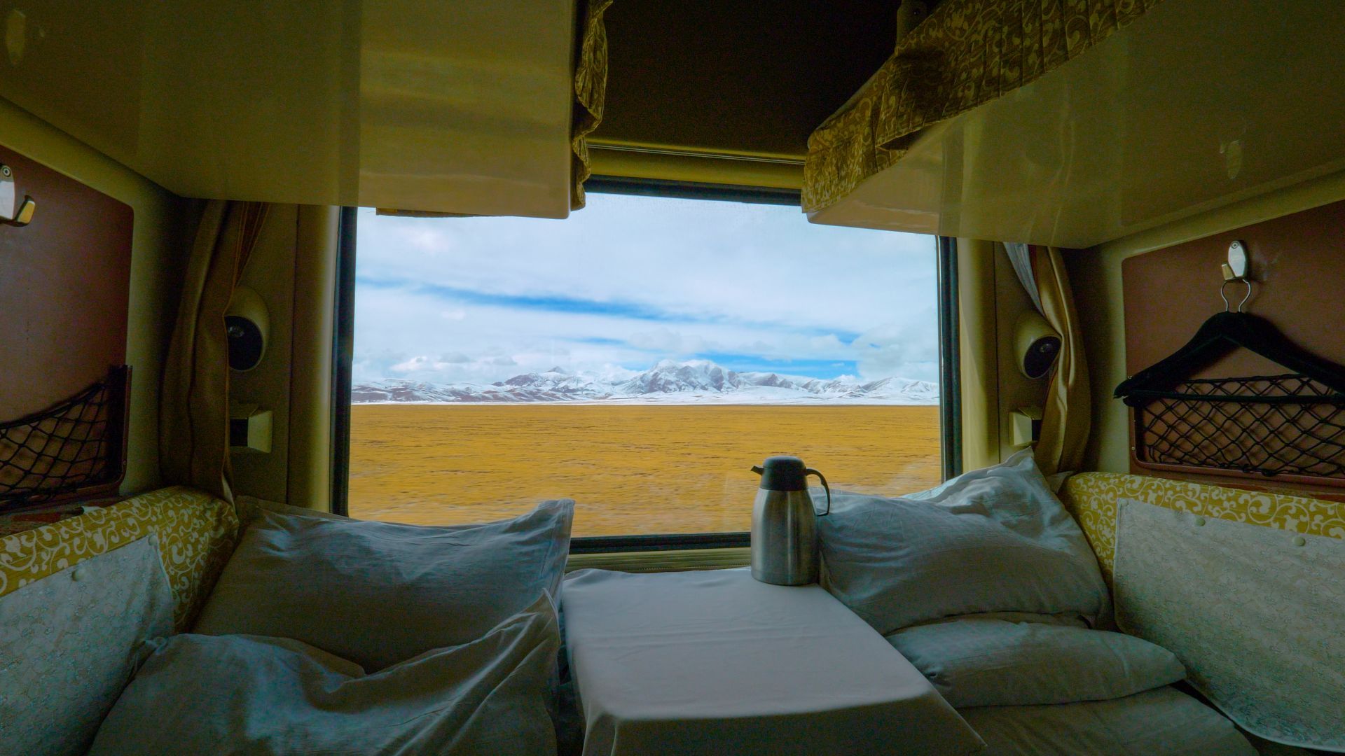 Mountains seen from the window of a train carriage.