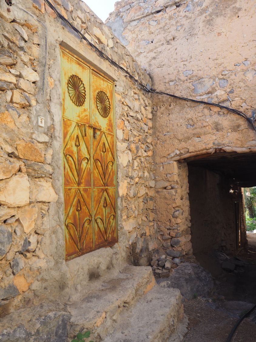 A door and mud wall detail from the mud village of Misfat Al Abriyeen 