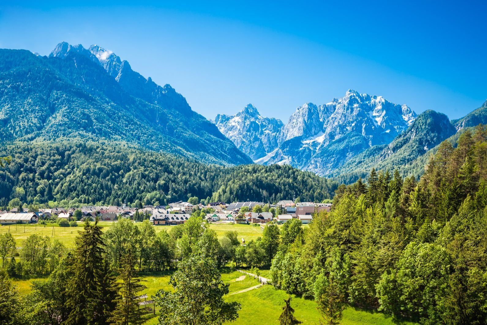 The beautiful town of Kranjska Gora in Slovenia, with the mighty Julian Alps behind