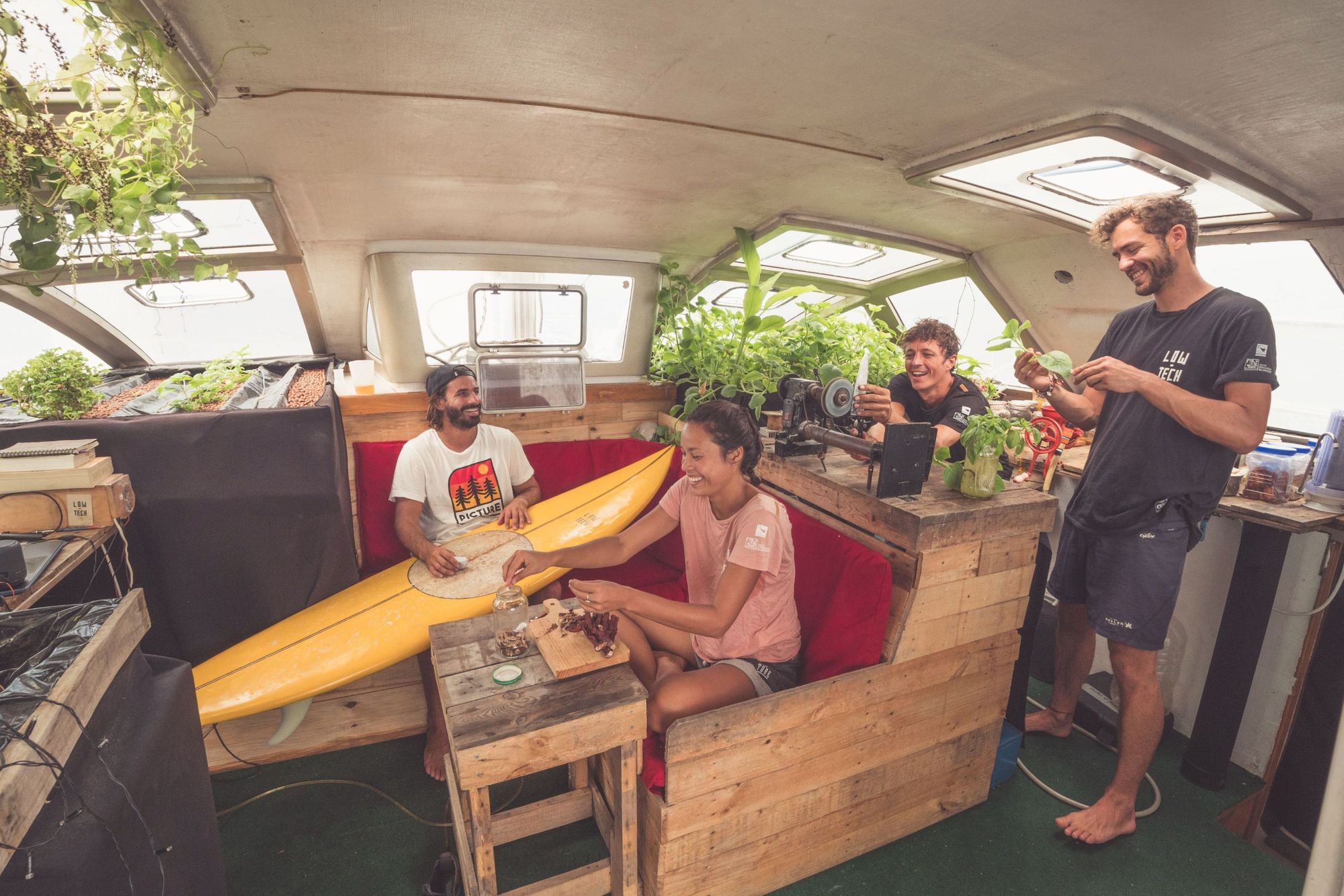 The crew from 'Wave of Change', a surf film, relaxing in their boat, Nomade des Mers