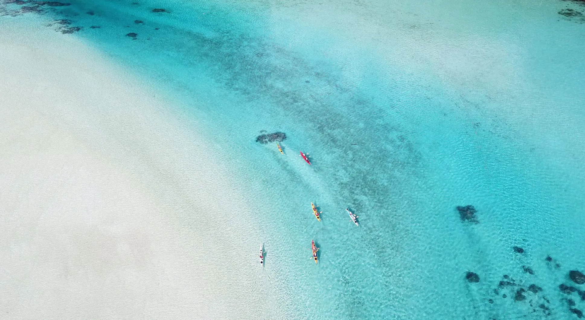An aerial view of sea kayakers in Indonesia.