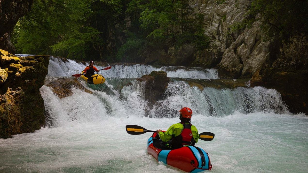 A packrafter going down a rapid.