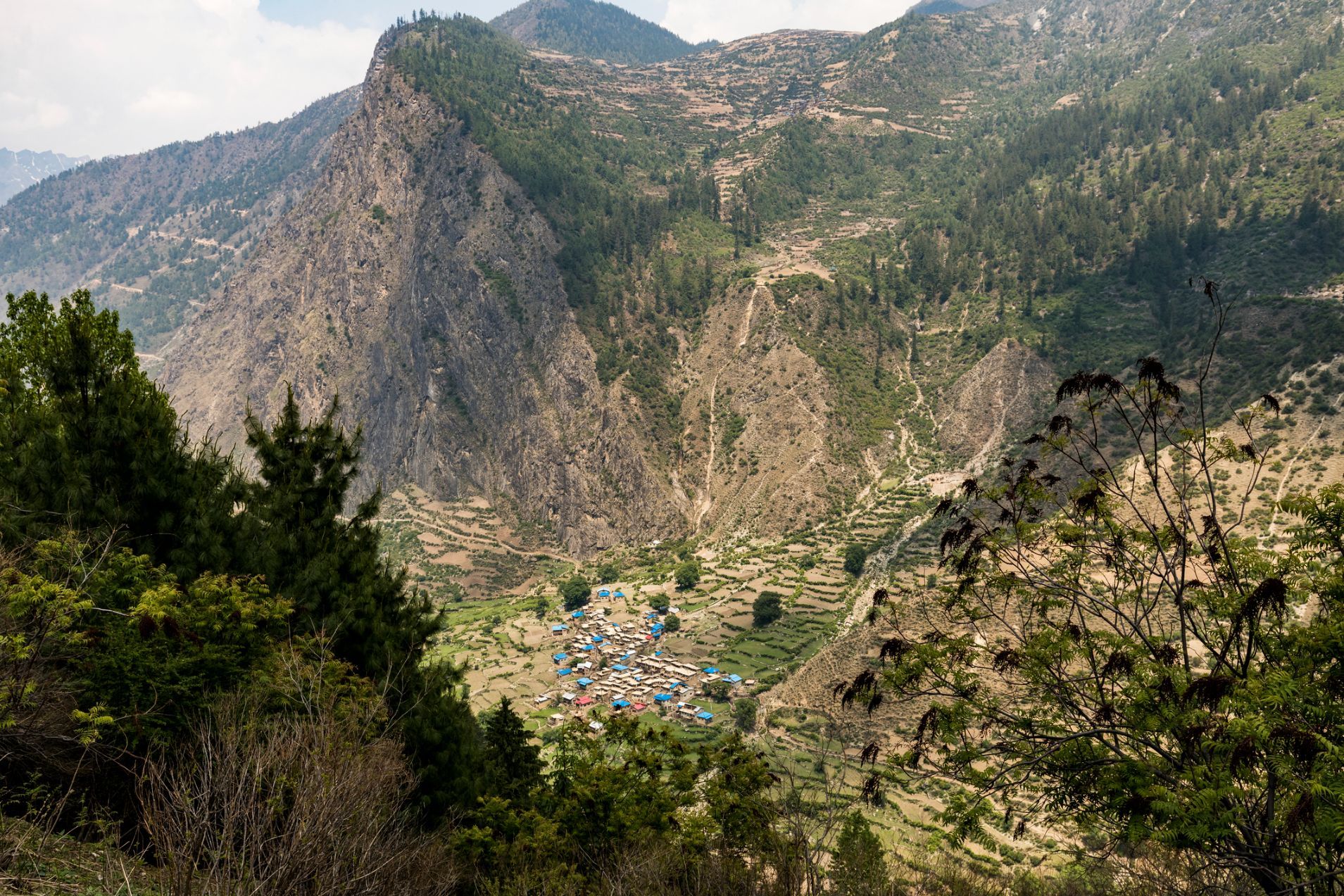 Himalayan village and terraces in a deep river valley in Simikot, in the west of Nepal.