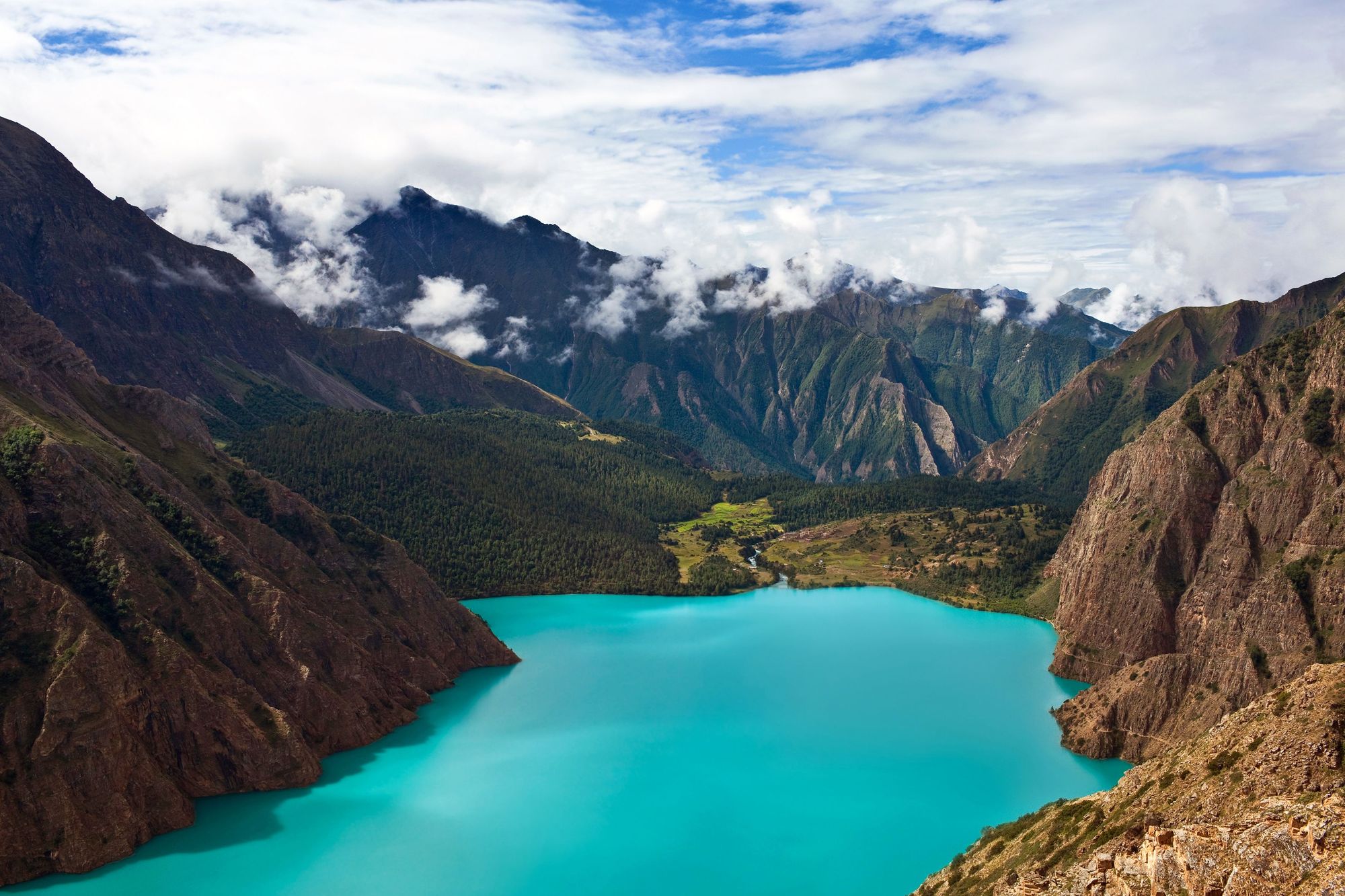 The remarkable turquoise blue colour of Lake Phoksundo, surrounded by mountains and forest on every side. It's a must see if trekking in the far west of Nepal.