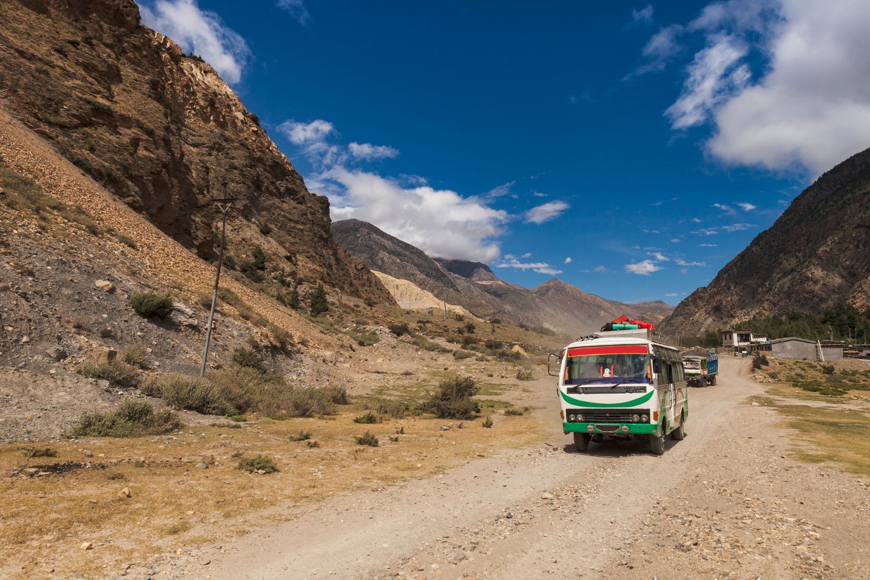 A tourist bus riding on the bumpy roads of the Annapurna region in Nepal