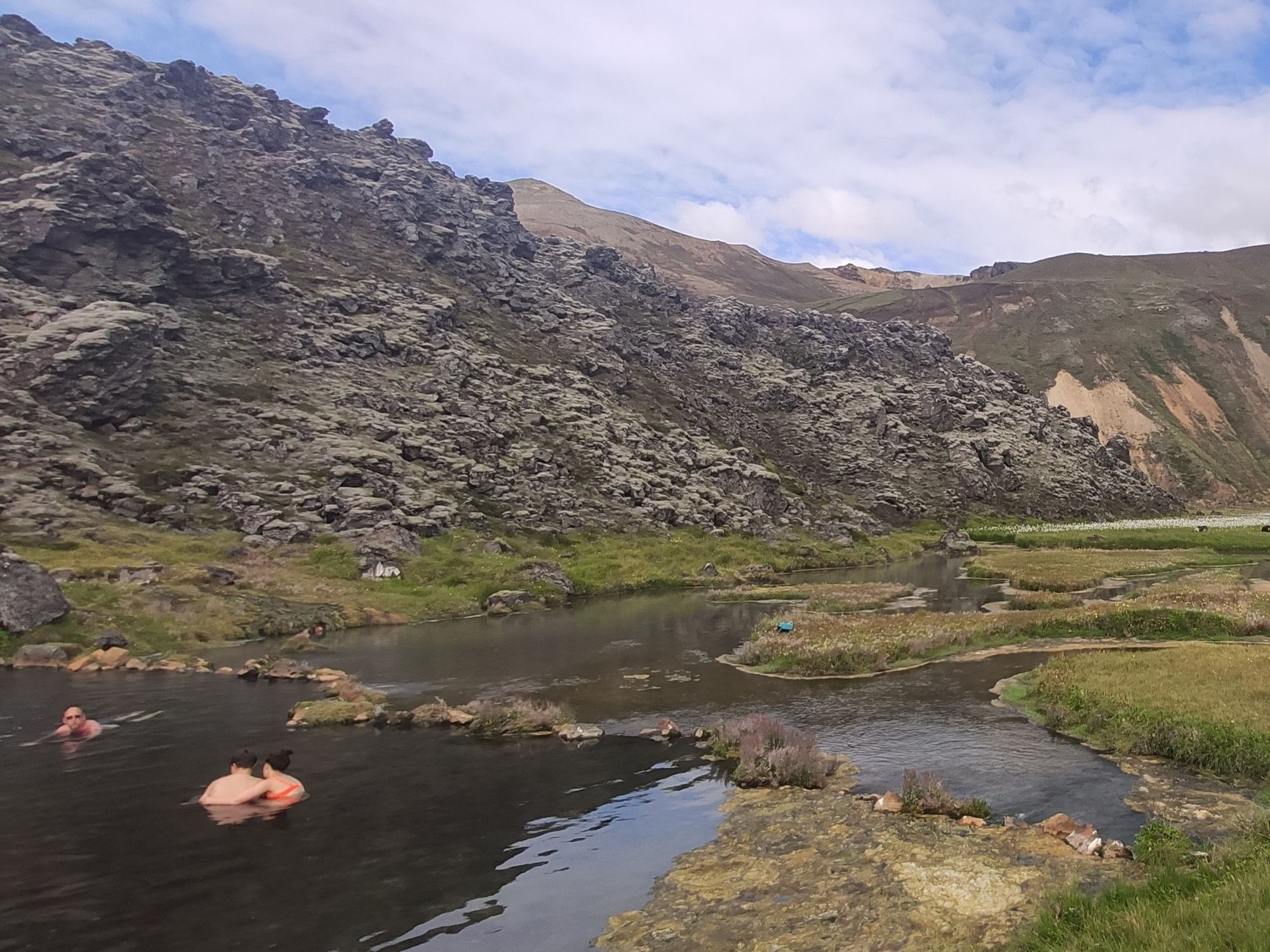 Swimmers in a geothermal pool in the hills of Iceland.