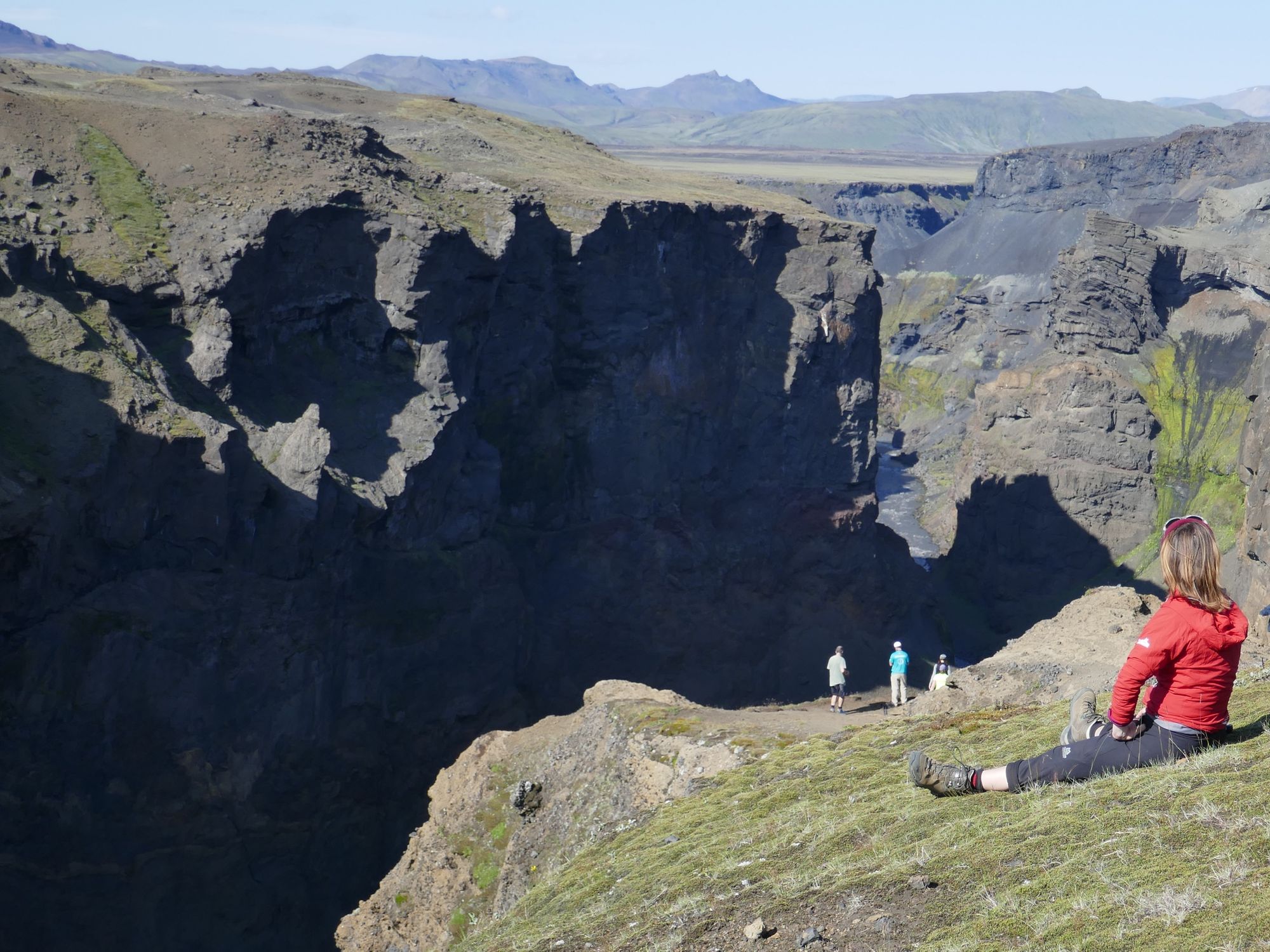 Hikers looking out at the Markarfljótsgljúfur Canyon in Iceland.