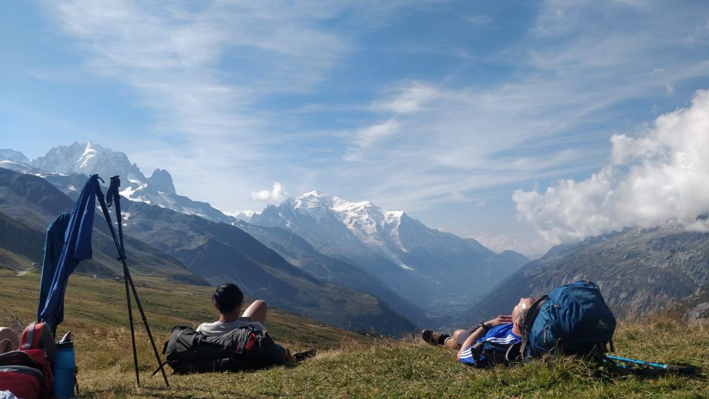 Hikers stop for a break - Mont Blanc and Aiguille du Midi in the background.