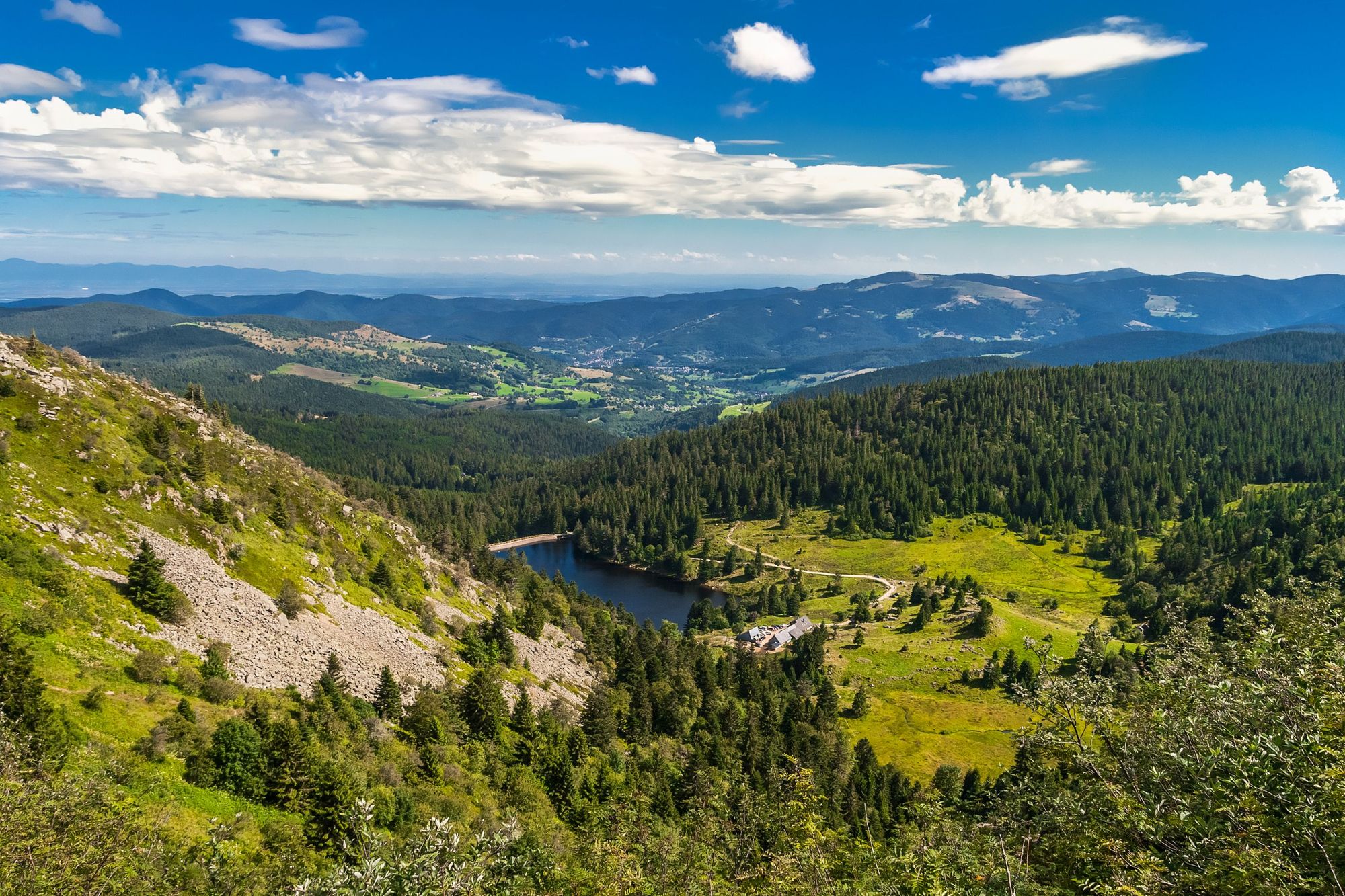 Looking down from the Gazon du Faing on the Forlet Lake in the Vosges Mountains in summer.