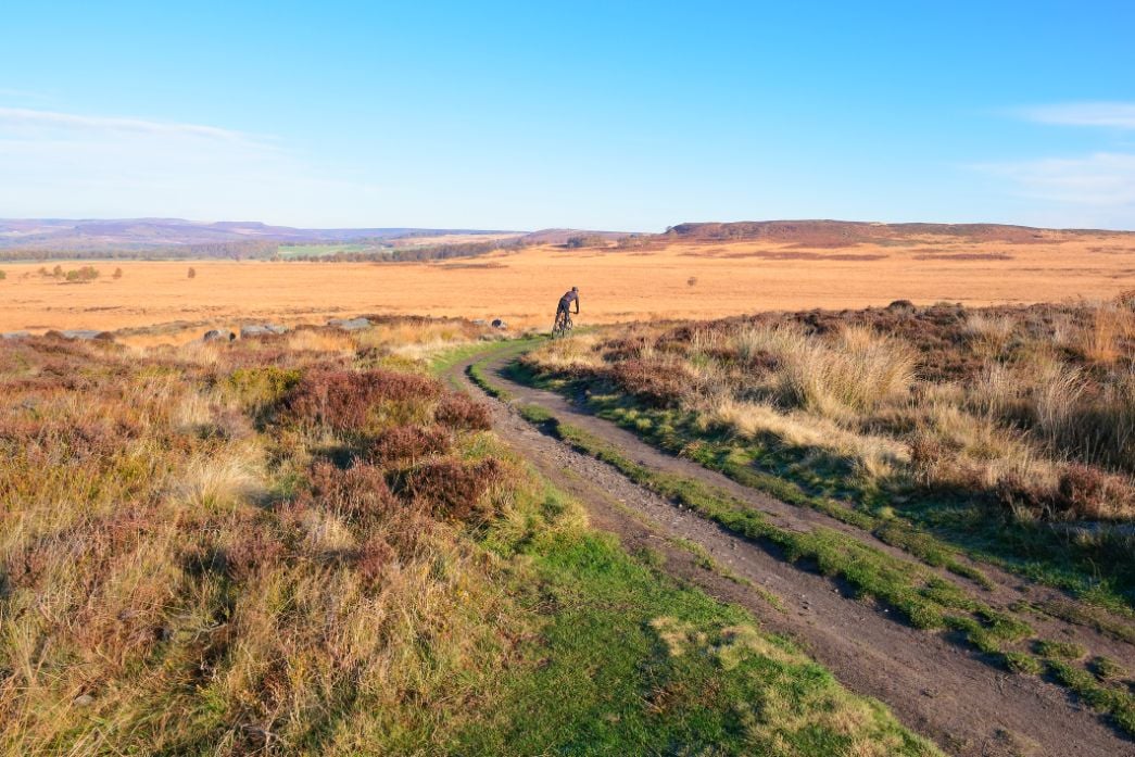 A cyclist in the Peak District, on the Penine Bridleway