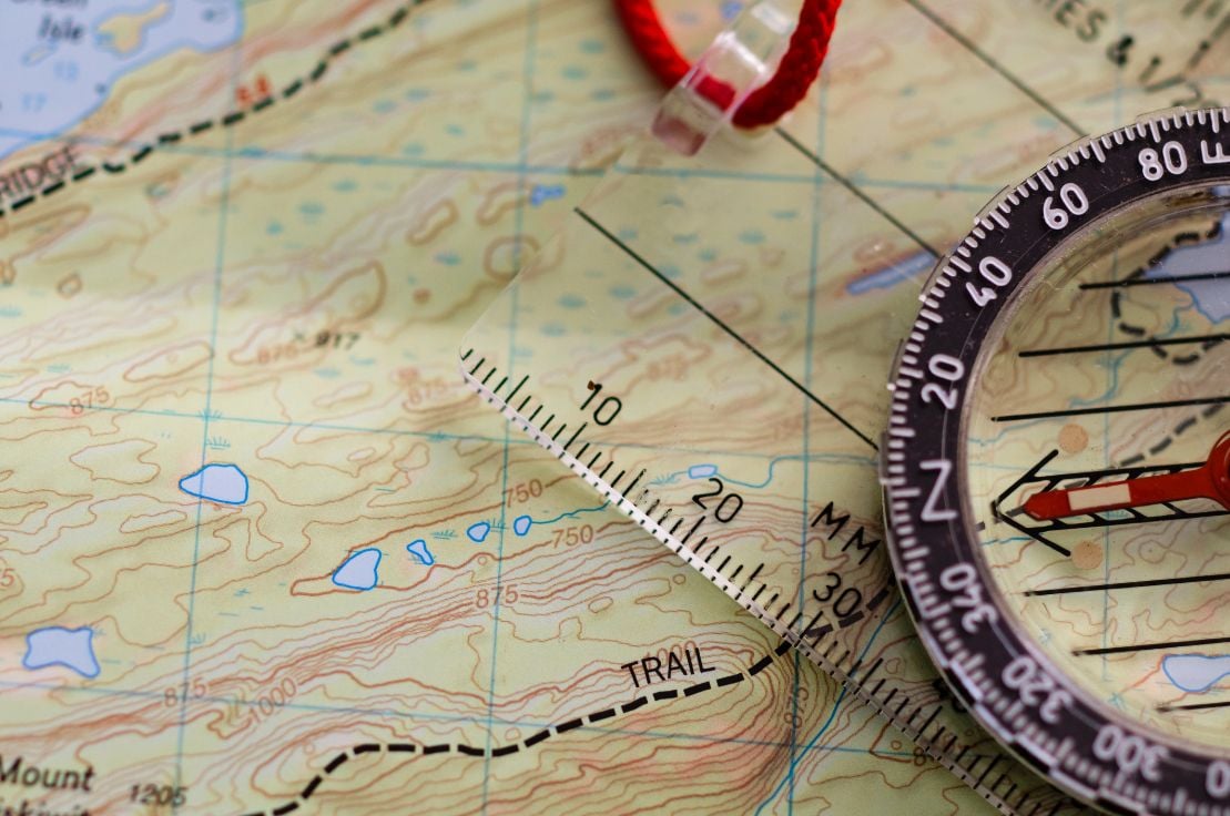 A close-up of a map and compass.