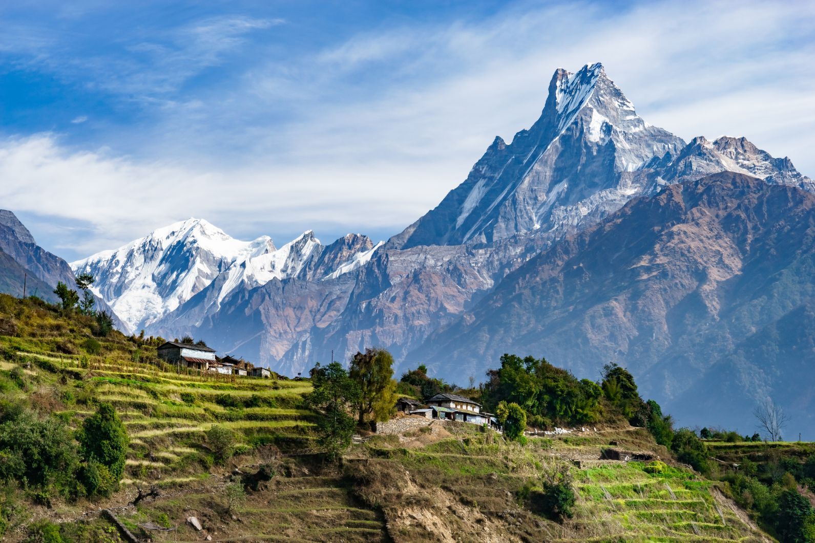 The spiky form of Machhapuchhre above terraced fields in Nepal, on the trek to Annapurna Base Camp