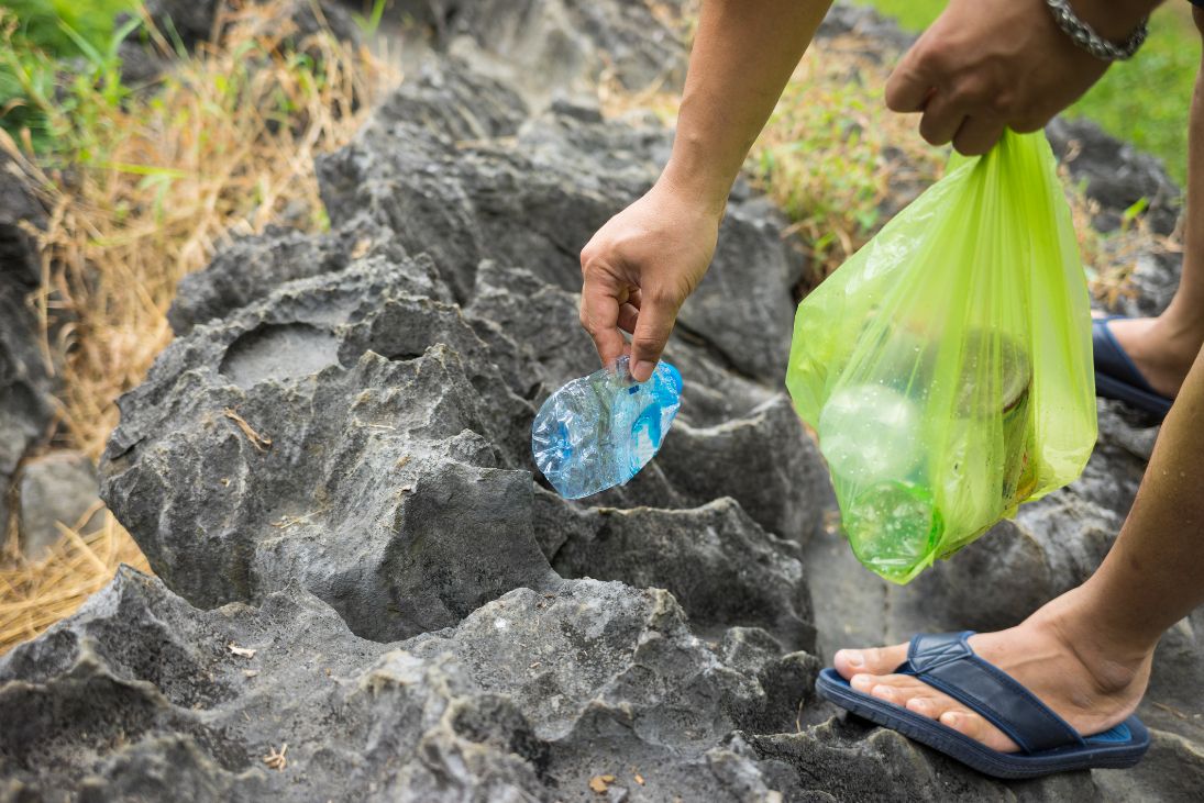 Someone picking up waste plastic.
