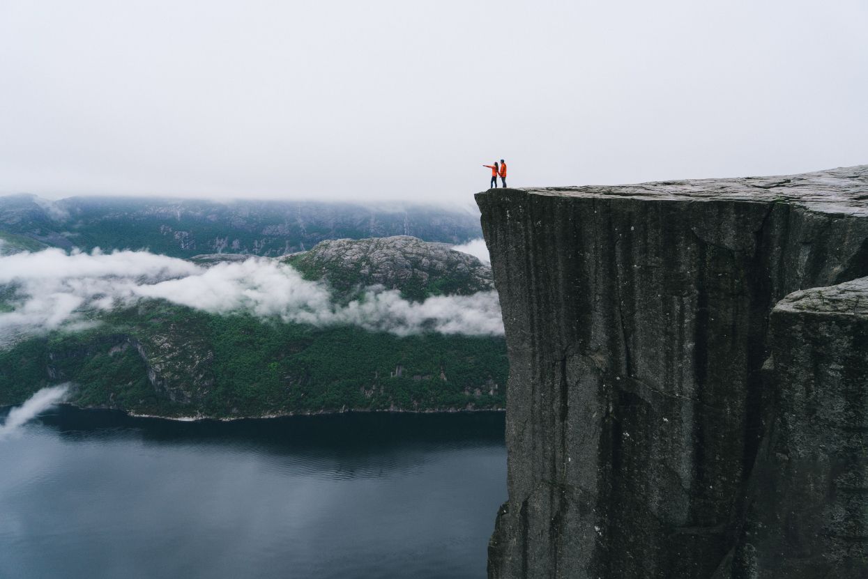 Two hikers on Preikstolen, the beautiful fjord in Norway.