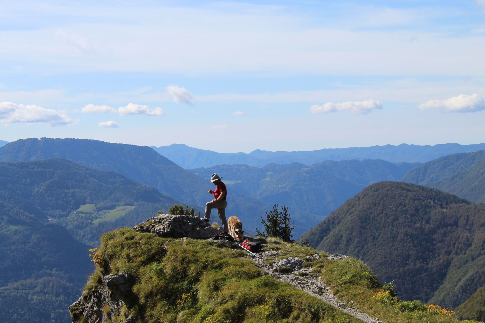 A local guide and his mountain rescue dog on stage eight of the Juliana Trail, from Podbrda to Bohinj.