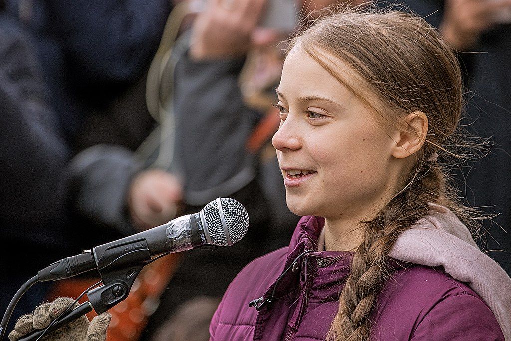 Climate activist Greta Thunberg giving a speech.