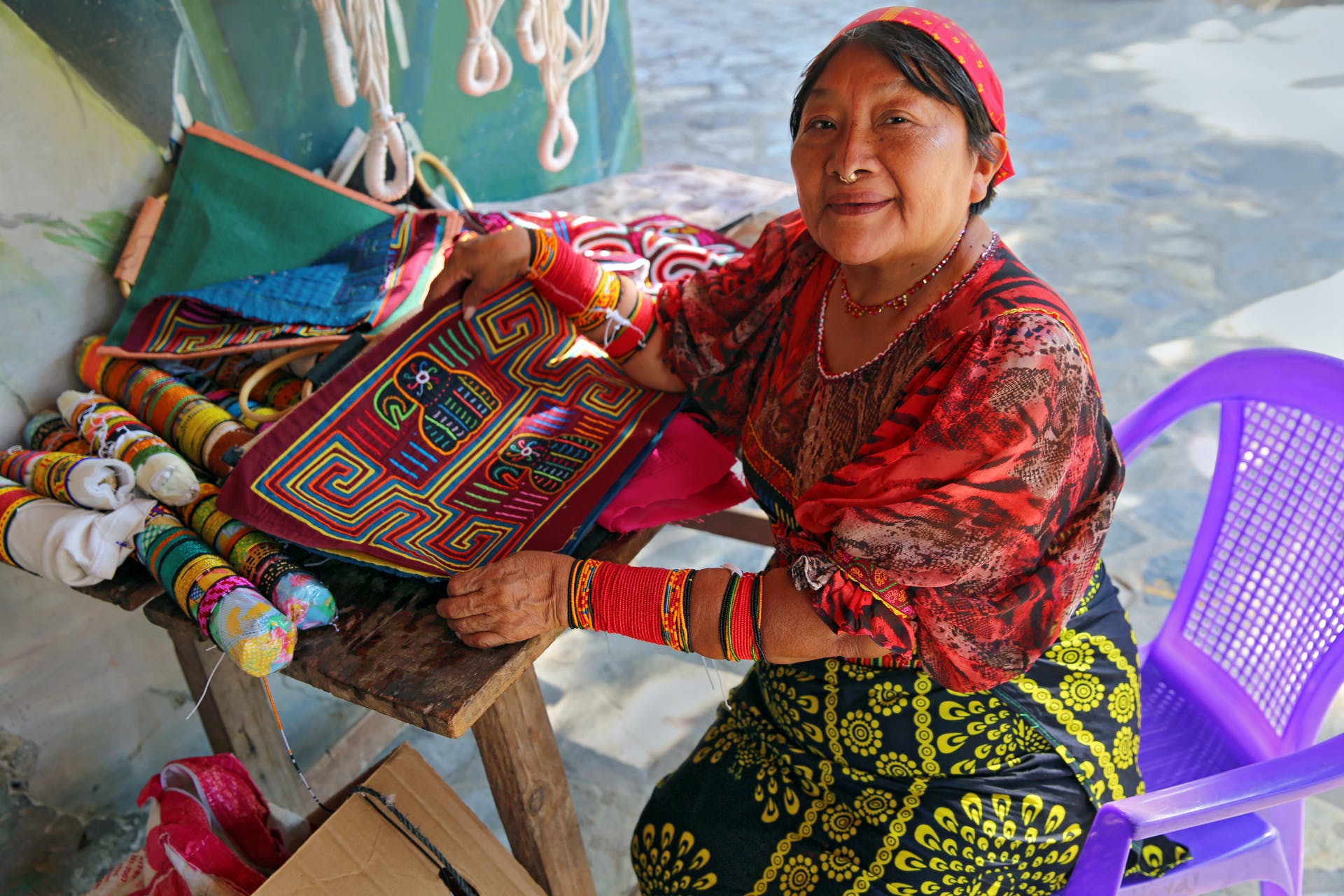 An indigenous Guna woman showcasing their unique style of 'Mola' artwork.