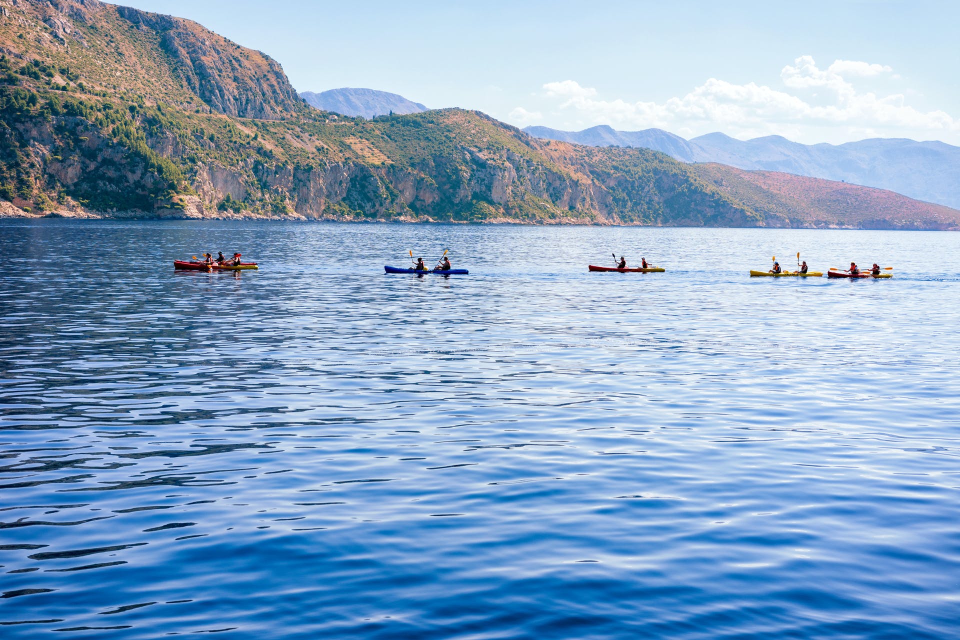 A group of sea kayakers on the calm seas in Croatia.