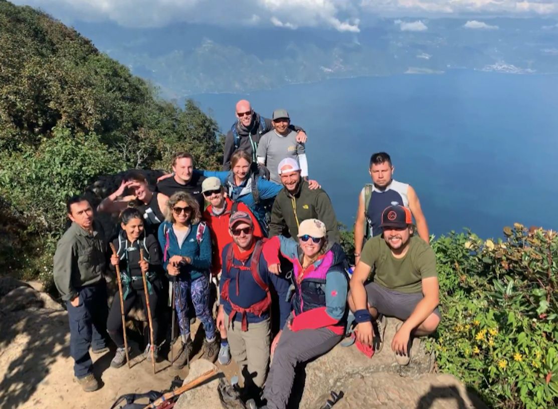 The group and guides, with Lake Atitlán below, on a Guatemala trekking adventure. Photo: Aleks Khapun