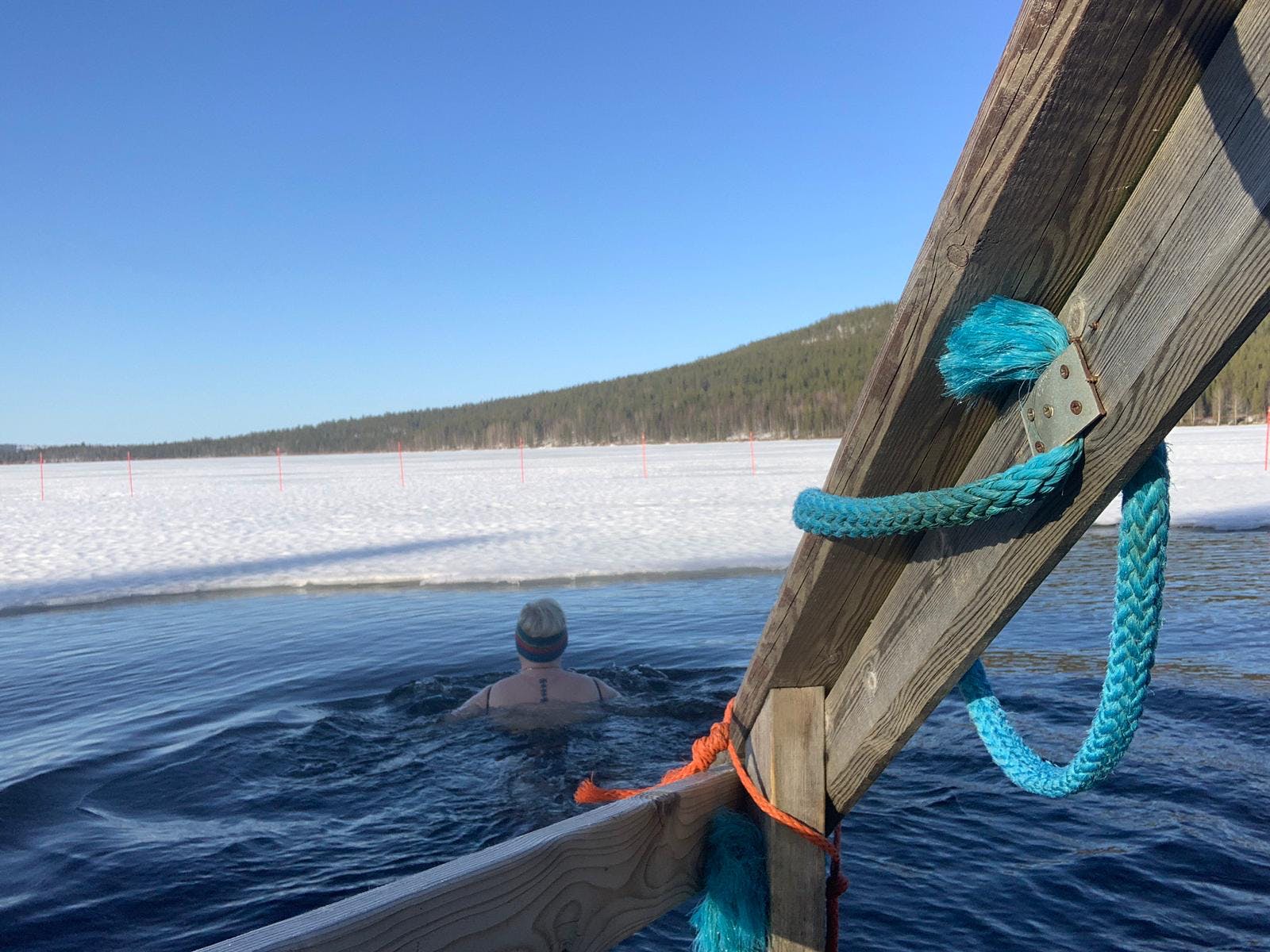 A swimmer plunges into an icy swimming hole in Finland.