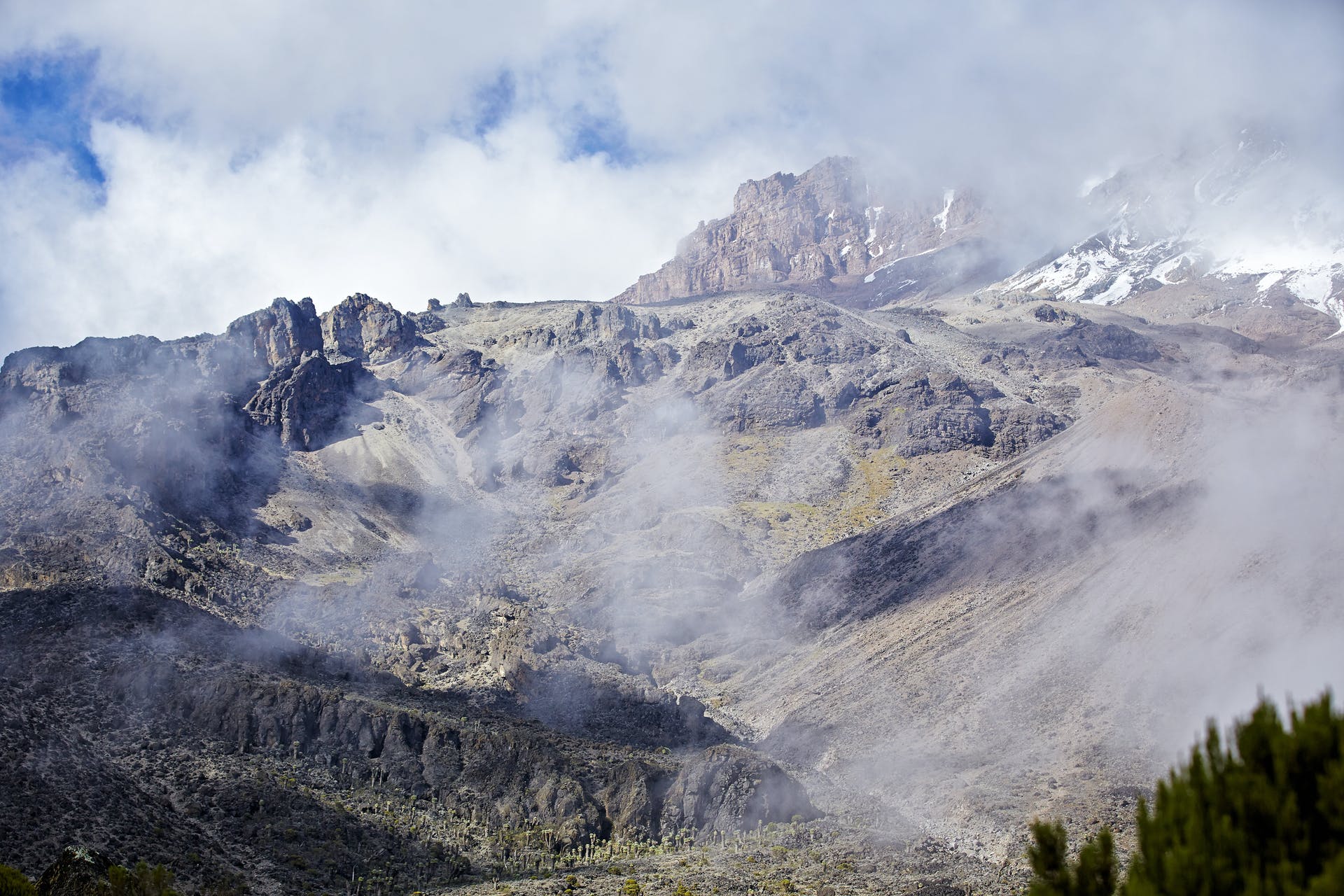 The summit of majestic Mount Kilimanjaro, shrouded in cloud.