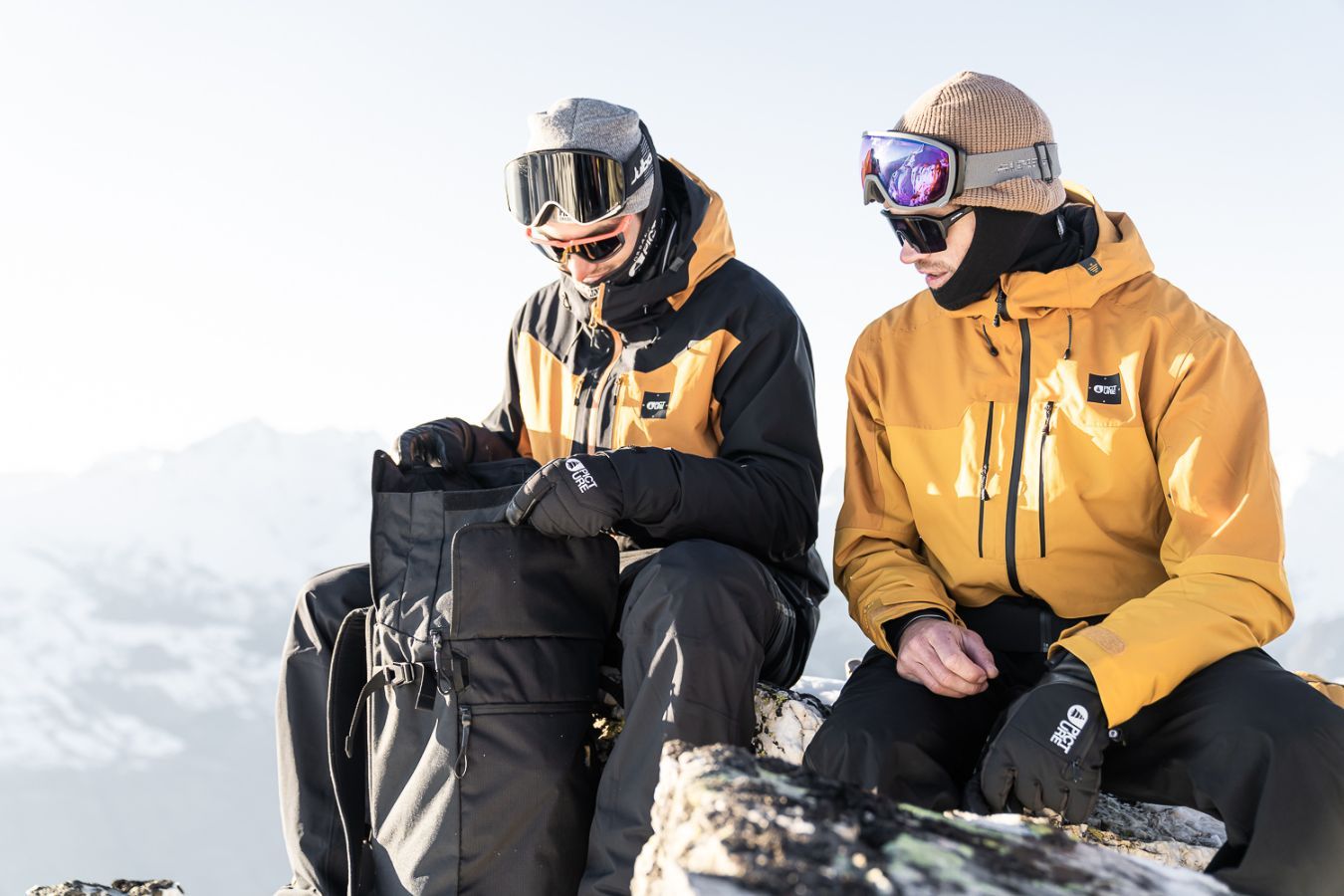 Two men wearing Picture Organic rental ski gear