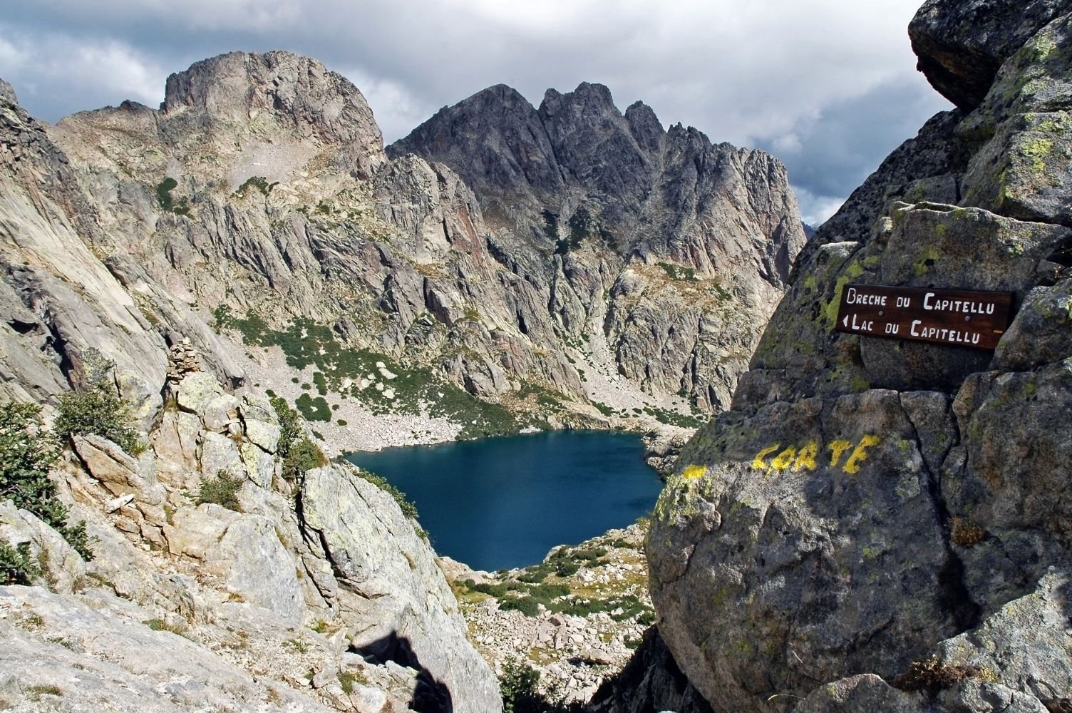 The beautiful Lac de Capitellu (Capitellu lake) on the GR20 trail, hidden away between the rugged mountains