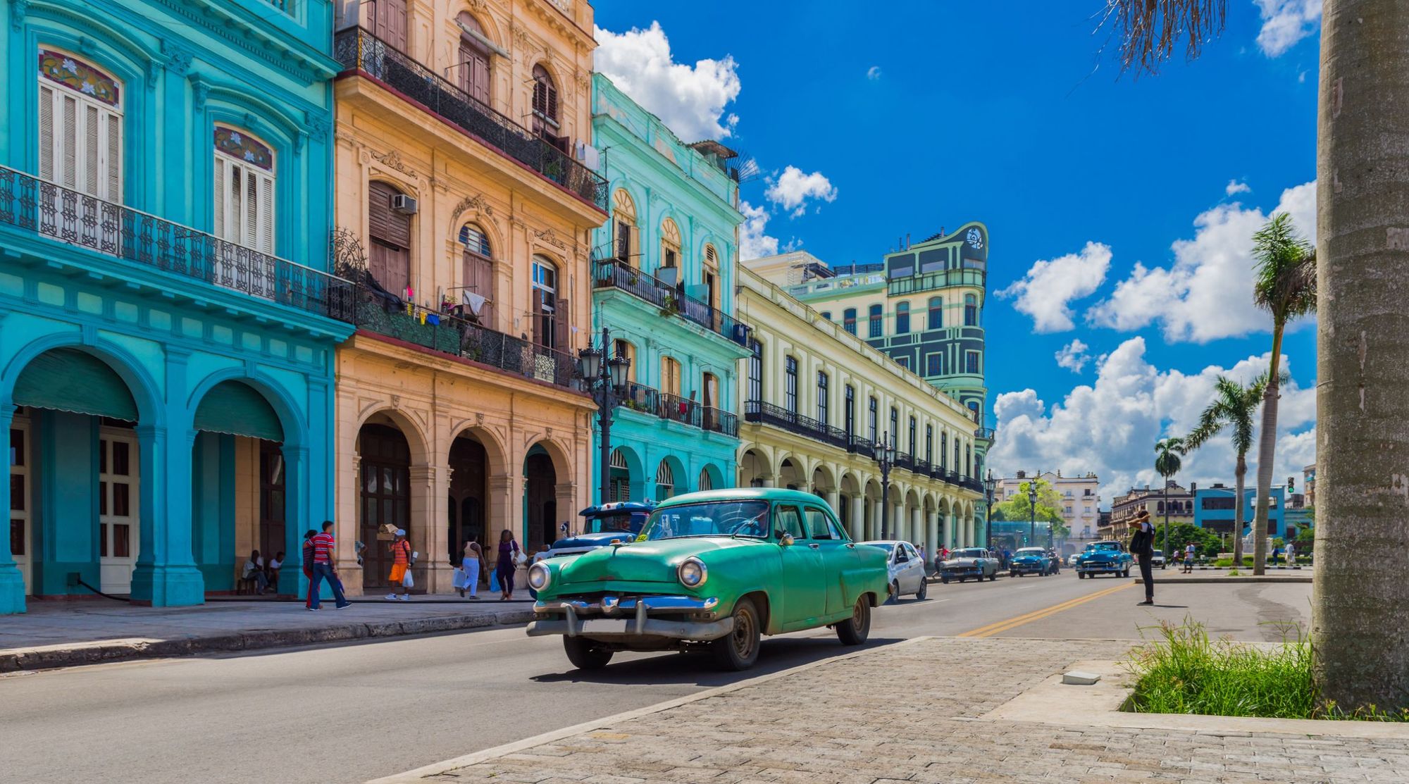 A typical scene in Havana, the Cuban capital, as a vintage American car drives past brightly coloured buildings. Photo: Getty