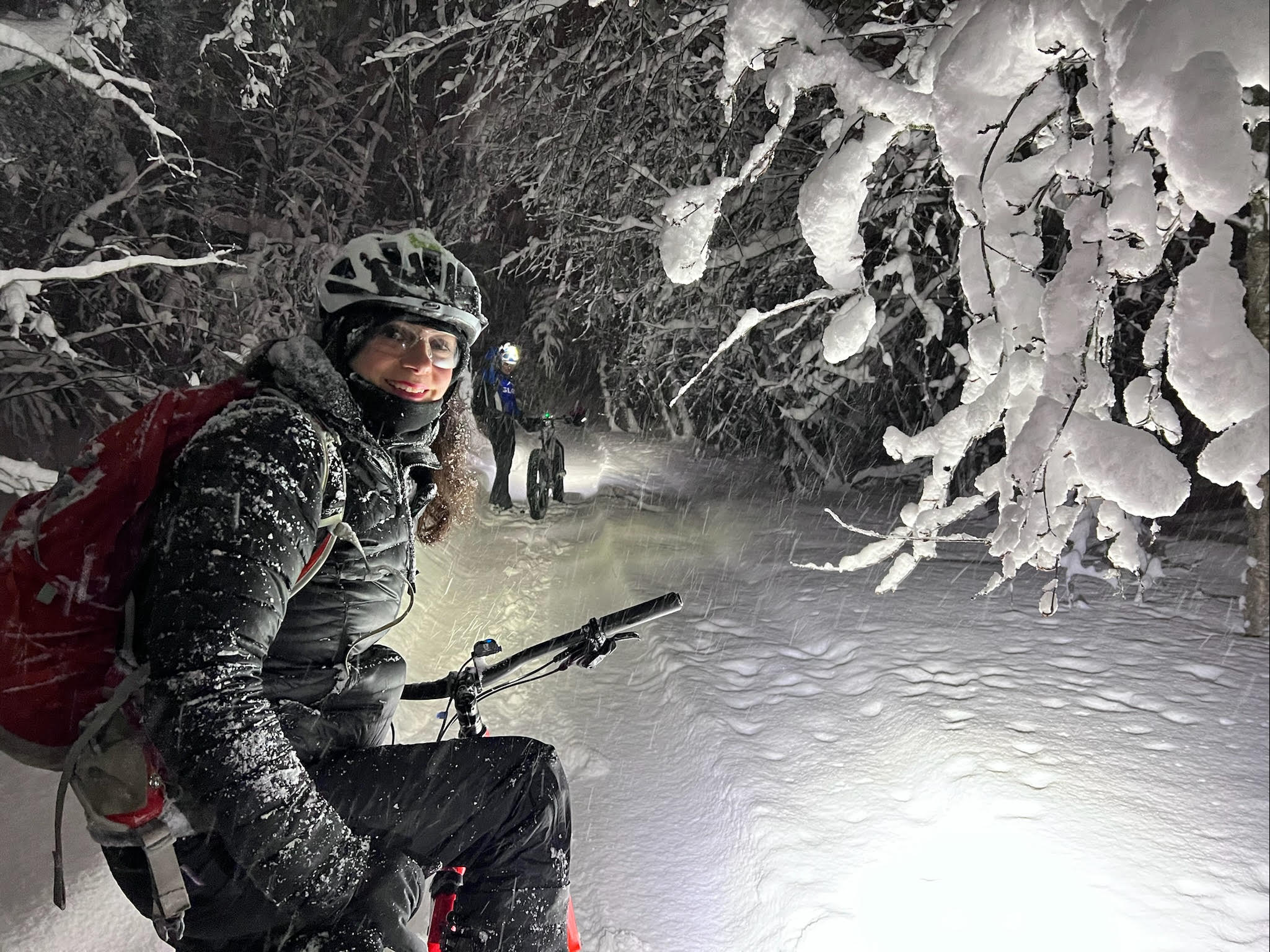 Fat biking in a snow storm, in a snowy forest.
