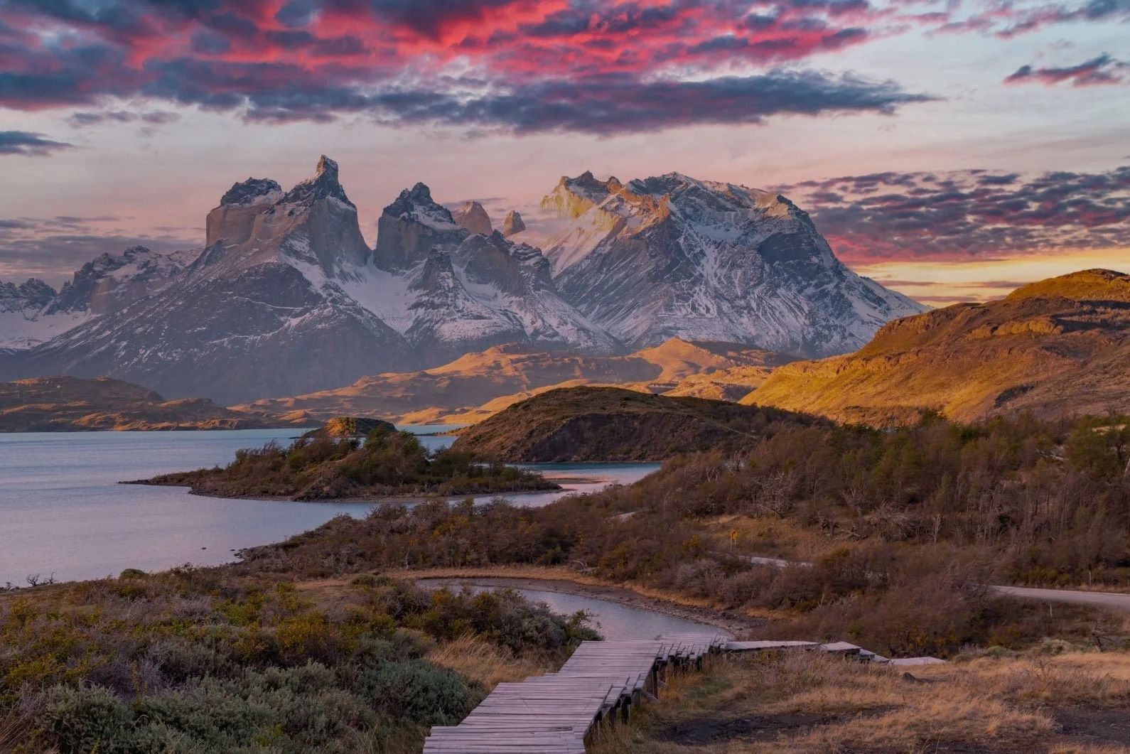 A boardwalk winding down through Patagonia, with stunning views of the Torres del Paine mountains.