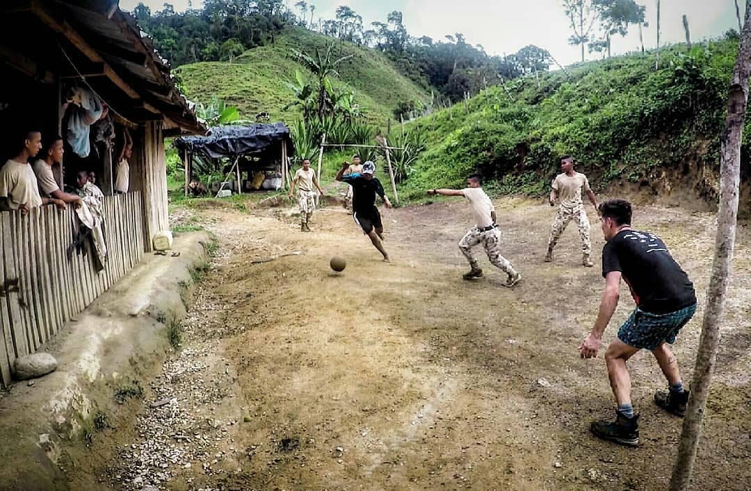 Colombian soldiers play football in the heart of the rainforest.