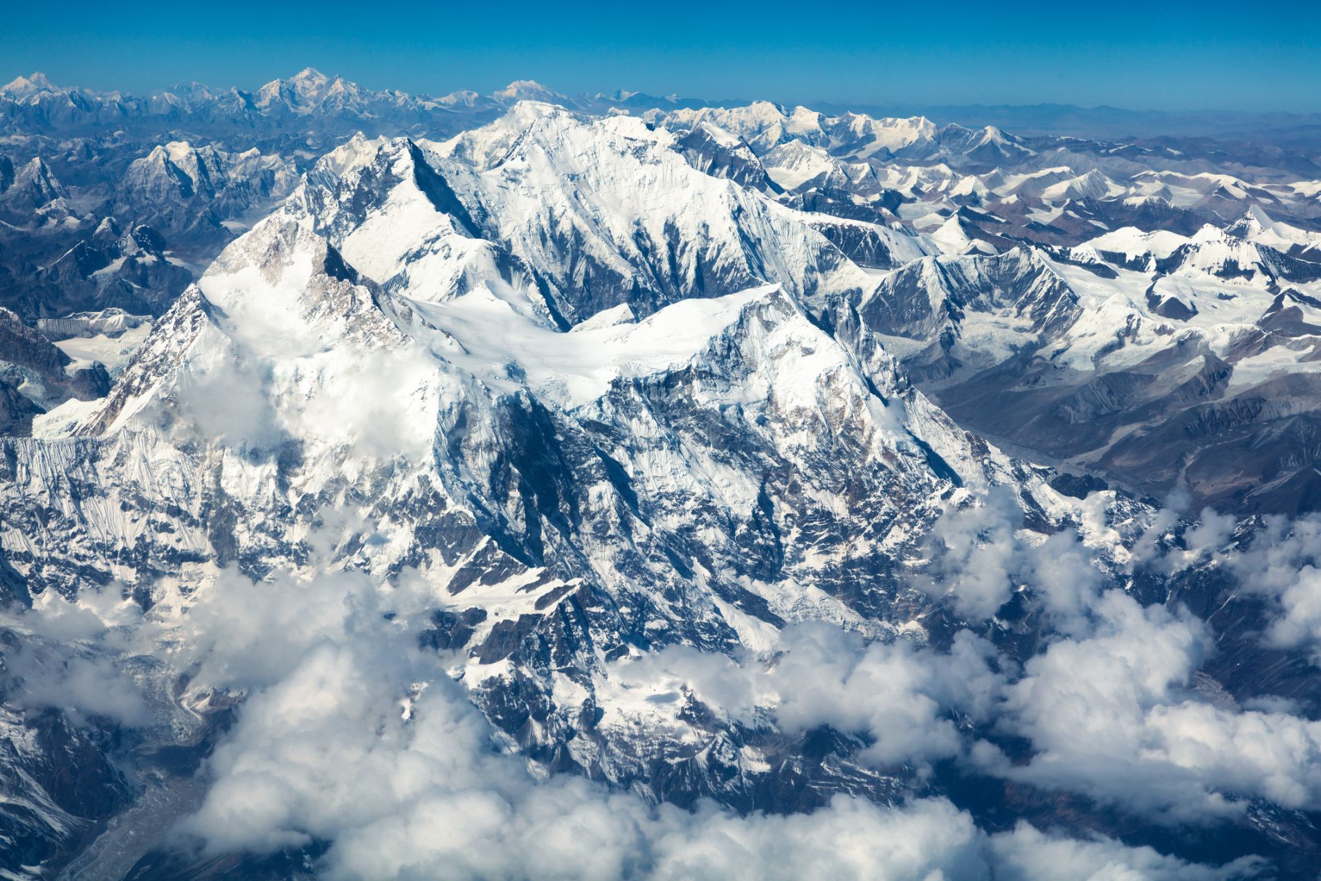 An aerial shot of Mount Everest and the neighbouring mountains in the might Himalayas of Nepal.