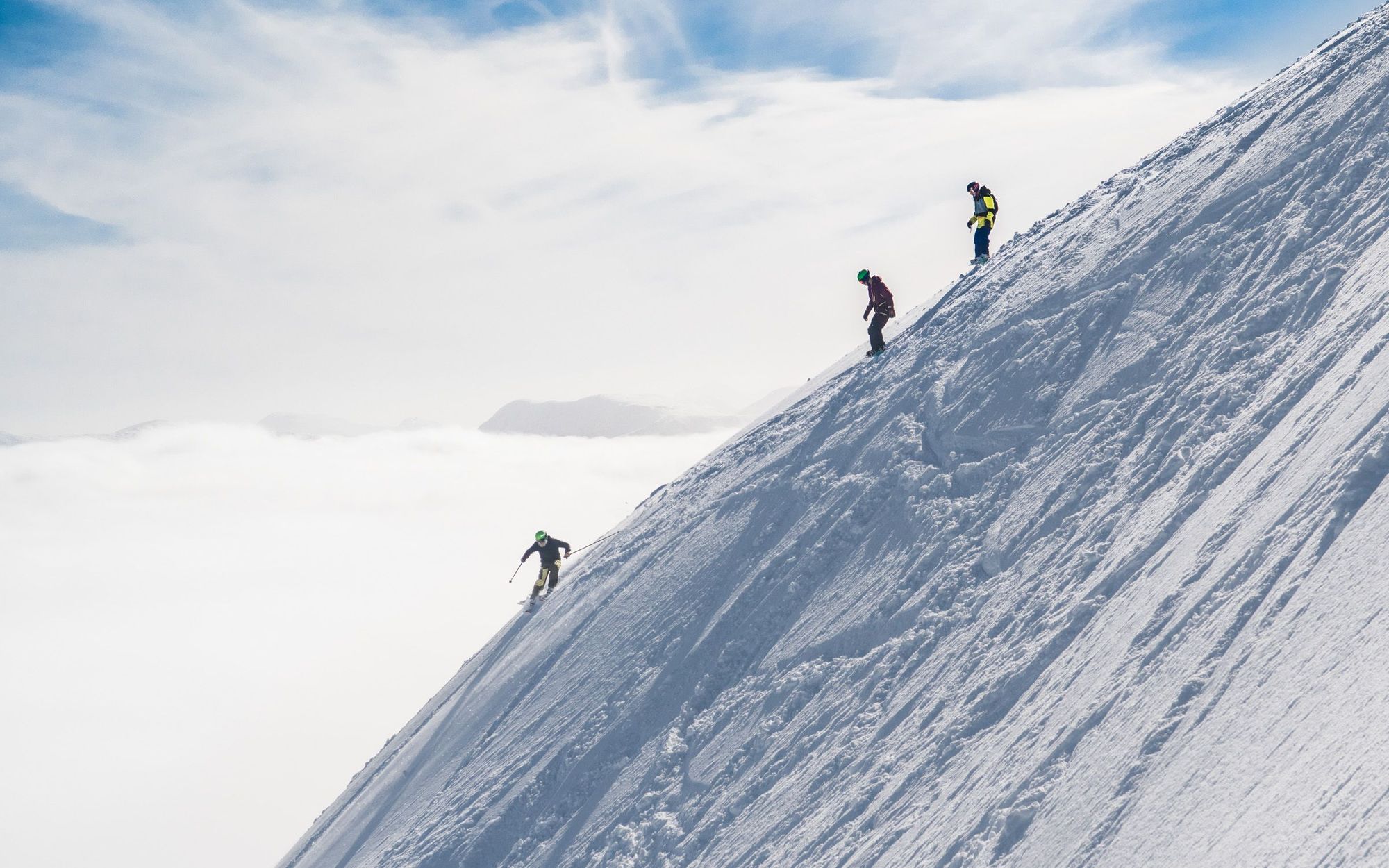 Skiers taking on the steeps of Glencoe, with a cloud inversion beyond. Photo: Snowsport Scotland