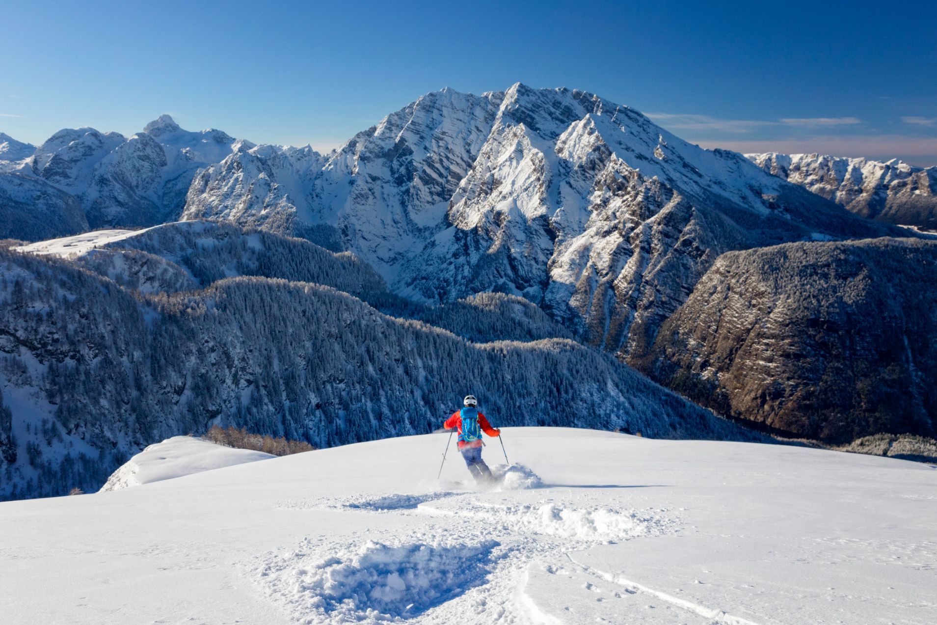 Someone skis off piste down a mountain in Scotland.