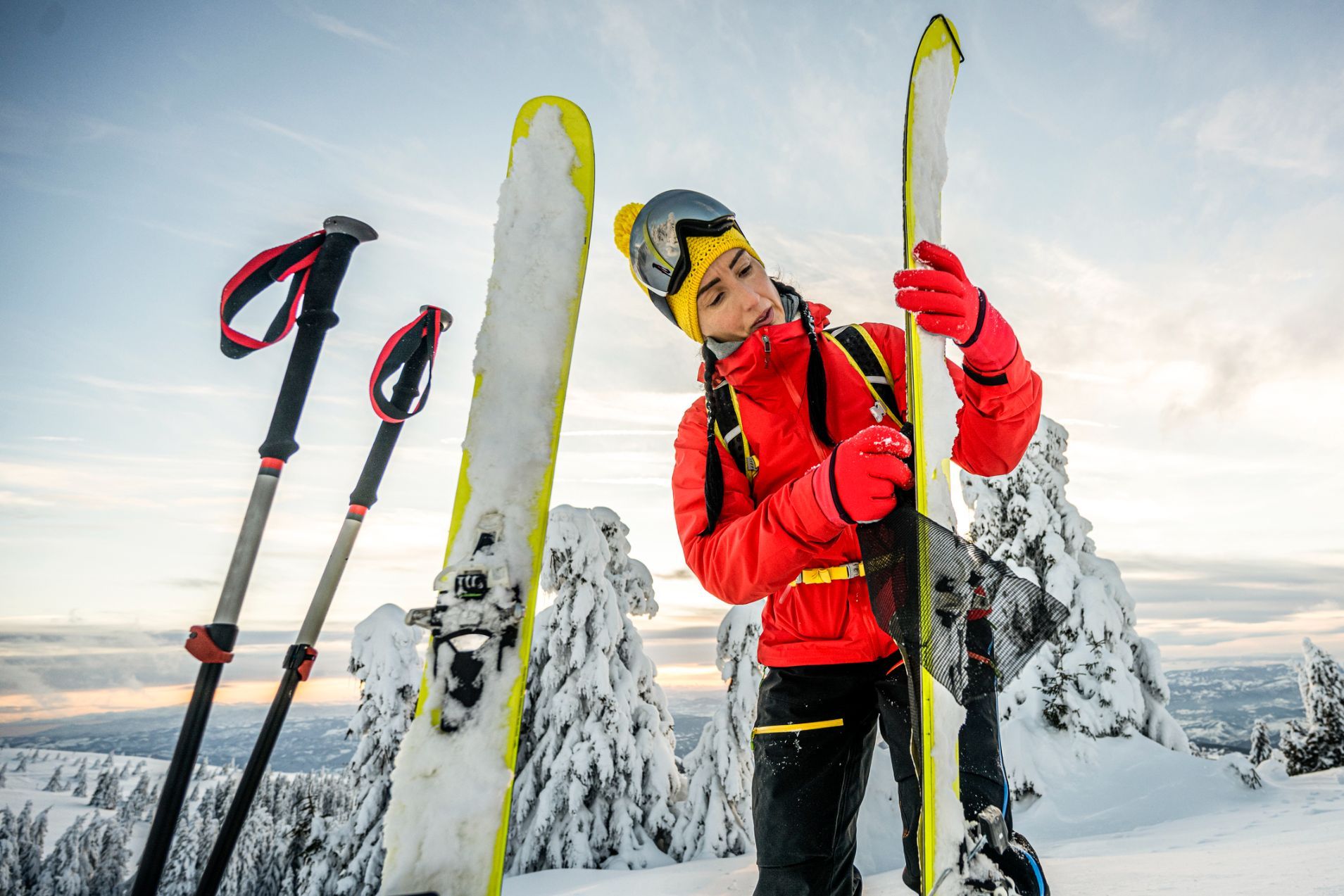 A female skier examines her skis
