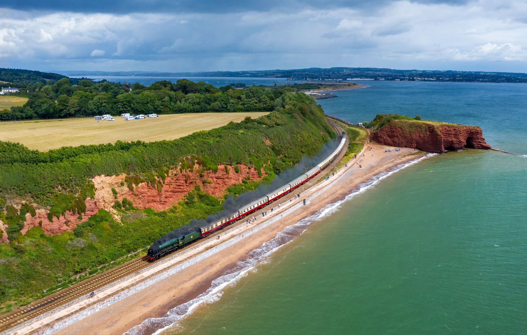 A drone image showcasing a steam train leading the way along the famous Dawlish Sea Wall. Photo: Getty