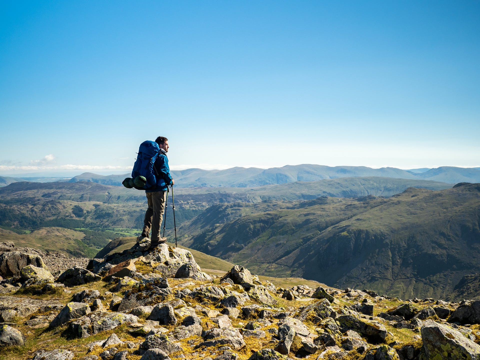 A hiker climbing the mountains of the Lake District
