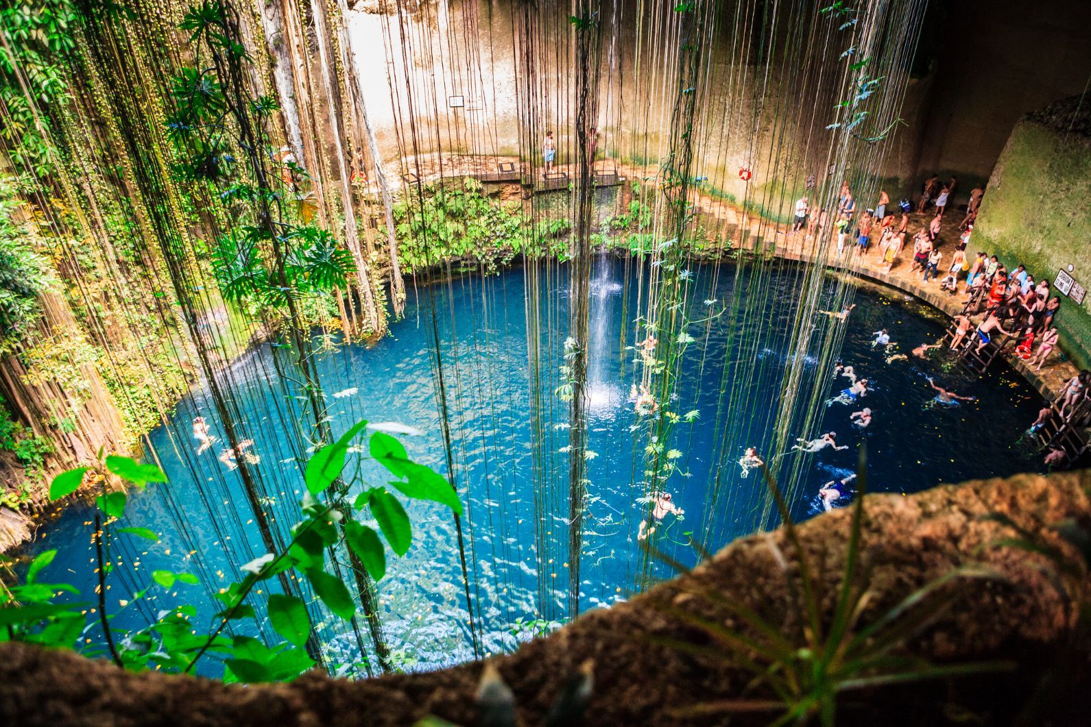 Crowds swimming in the Cenote Ik-Kil in Mexico