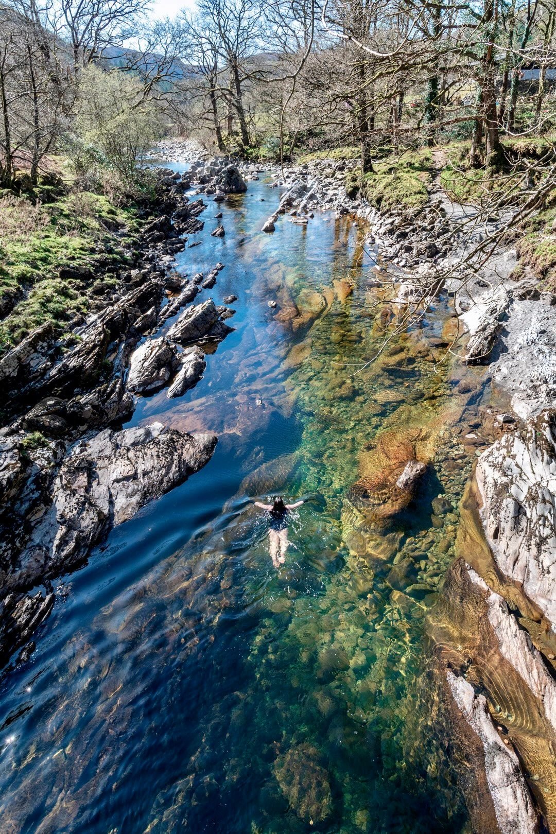 Laura Owen Sanderson swimming in a Snowdonia river.