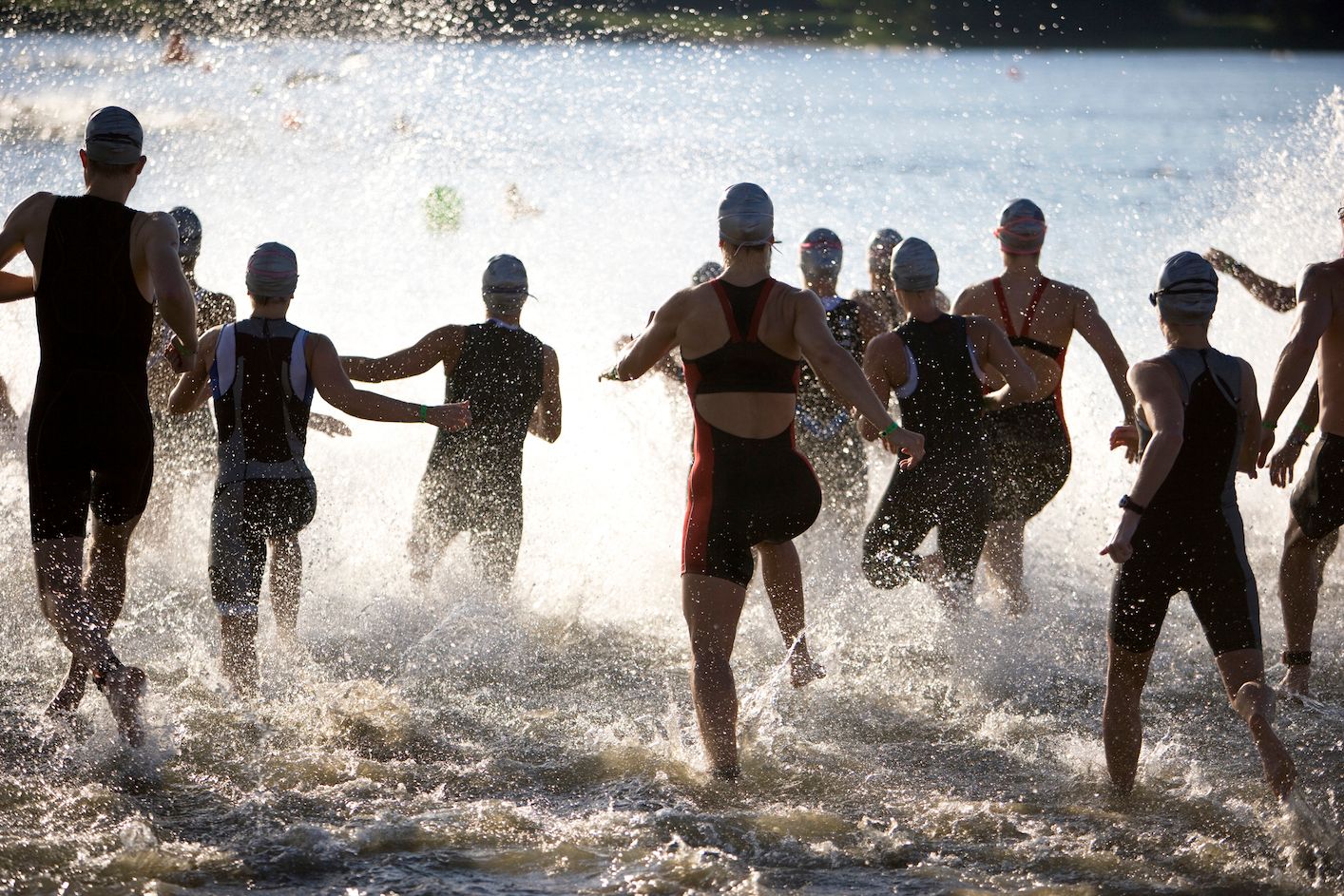 A crowd of swimmers entering the water.