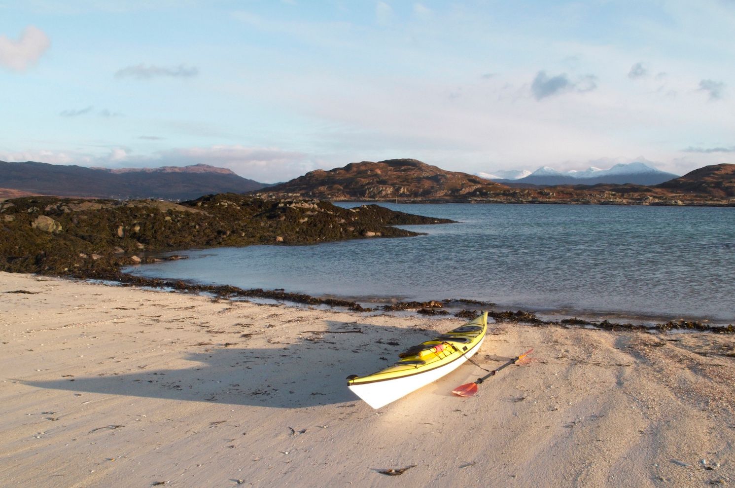A sea kayak beached on an Arisaig skerry