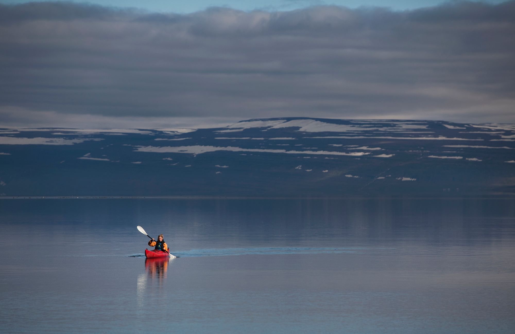 Woman kayaking in the Westfjords.