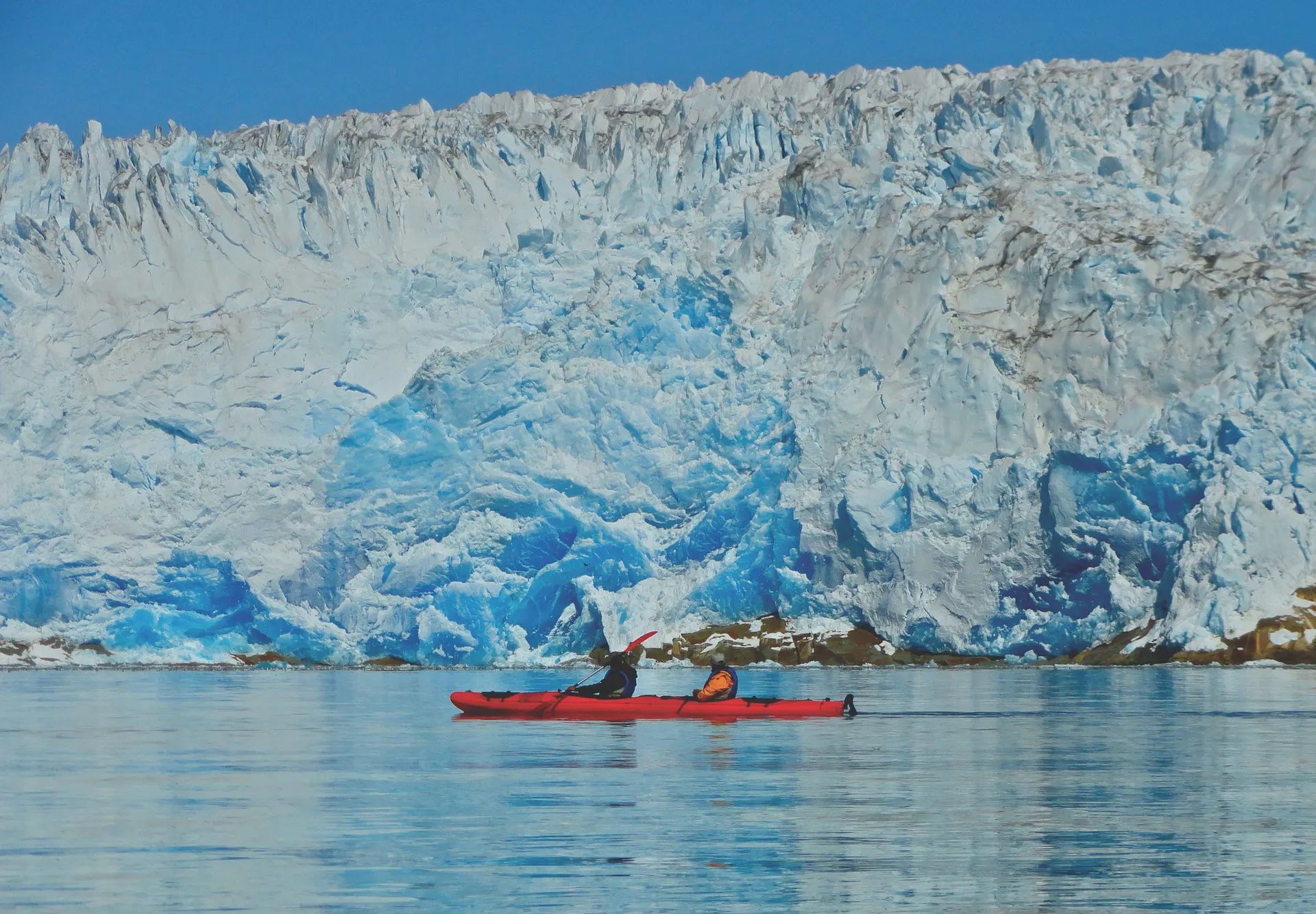 Kayaking in Greenland, passing a huge glacier.