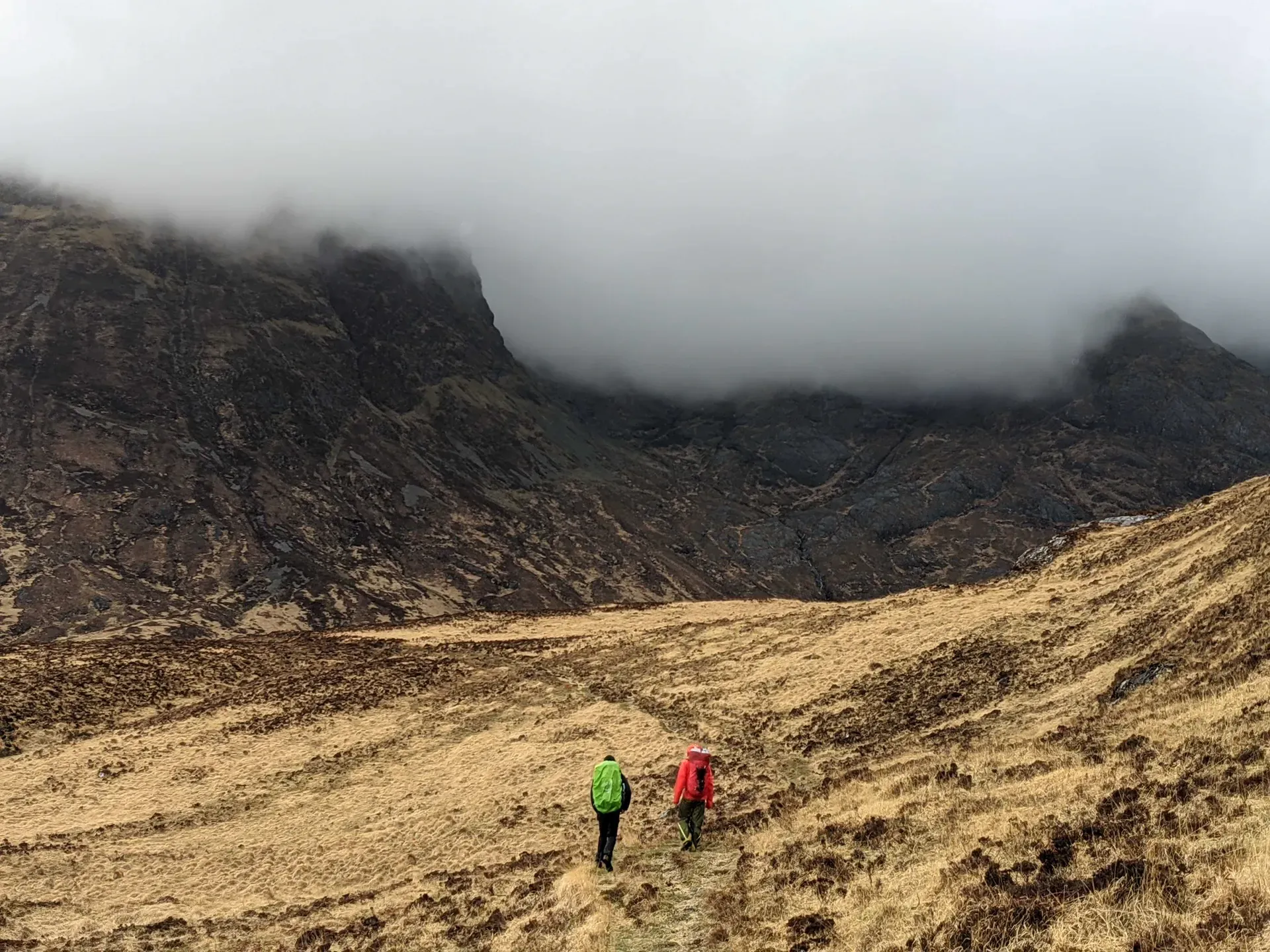 Hikers in a moody mountain landscape on the Isle of Rùm